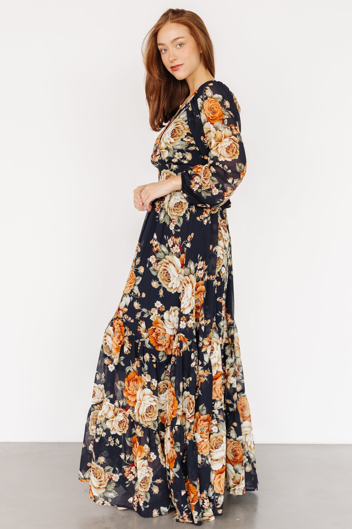 Detail shot of the chiffon fabric pattern and colorway: midnight navy background with orange, yellow and green floral motifs.