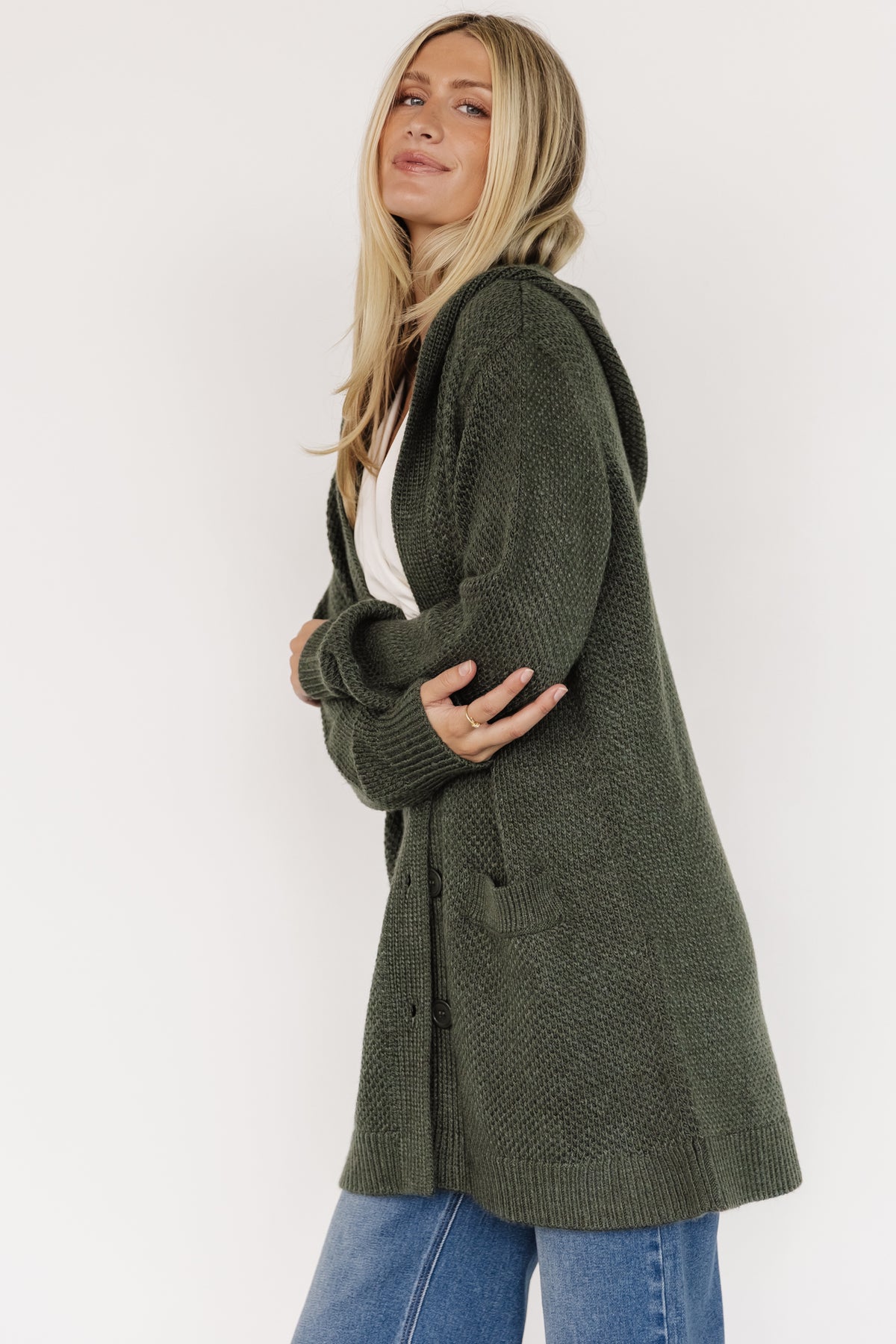 Styled outfit image: Katrine hooded cardigan layered over a casual top and jeans, illustrating versatility and everyday wearable proportions.