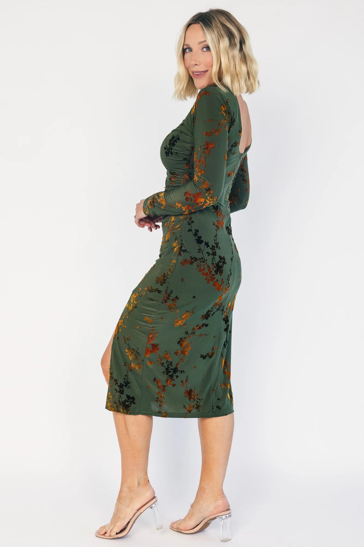 Green velvet floral midi dress with a boat neckline, long sleeves, side ruching, and a side slit.