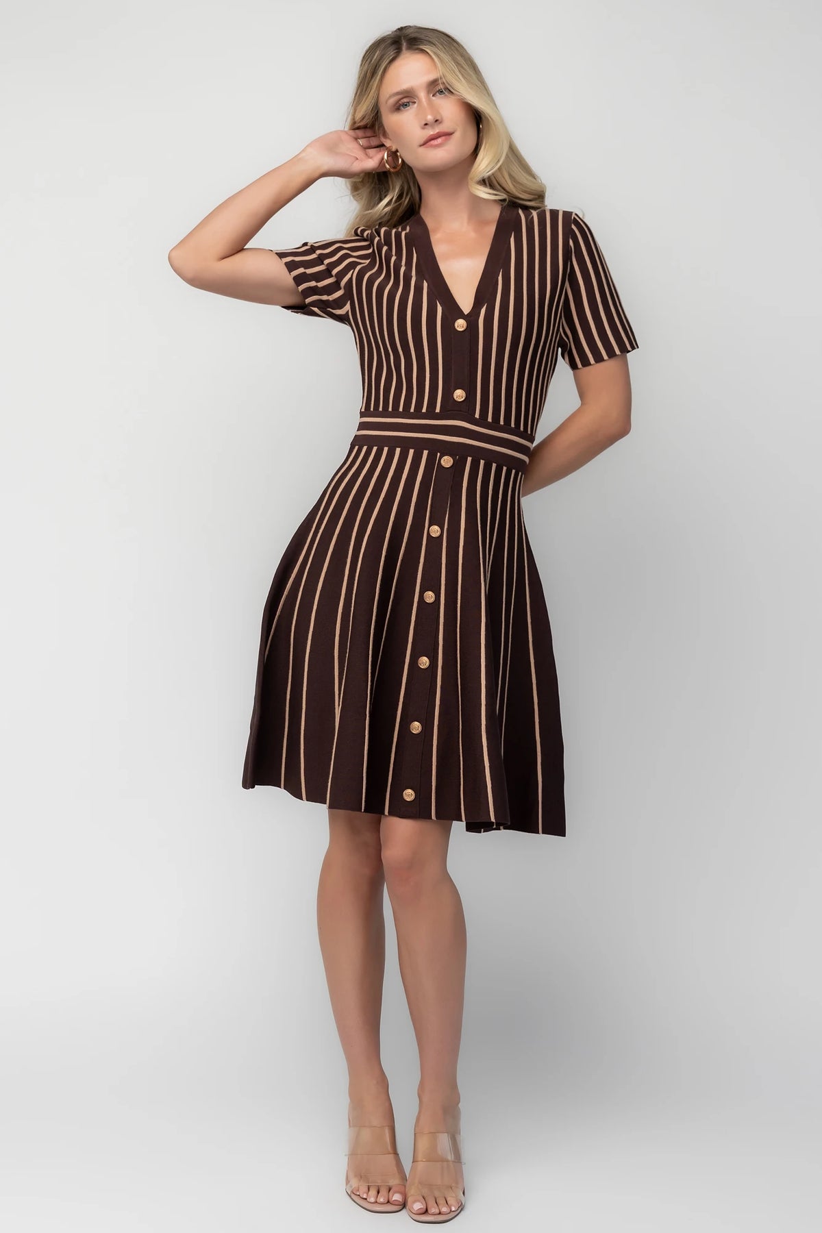 Model wearing the Tate Striped Short Dress in Brown + Beige featuring a soft sweater knit with beige vertical stripes.