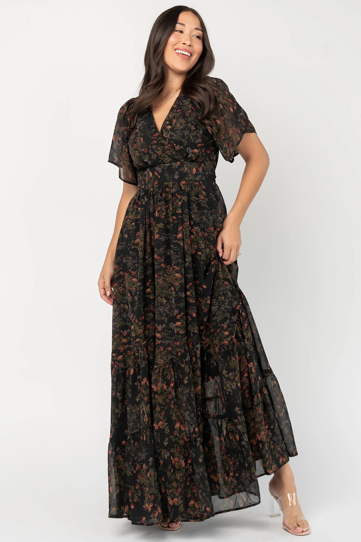 Katherine Maxi Dress in Black Multi Print with surplice V-neck, flutter sleeves, adjustable waist ties, and tiered skirt.