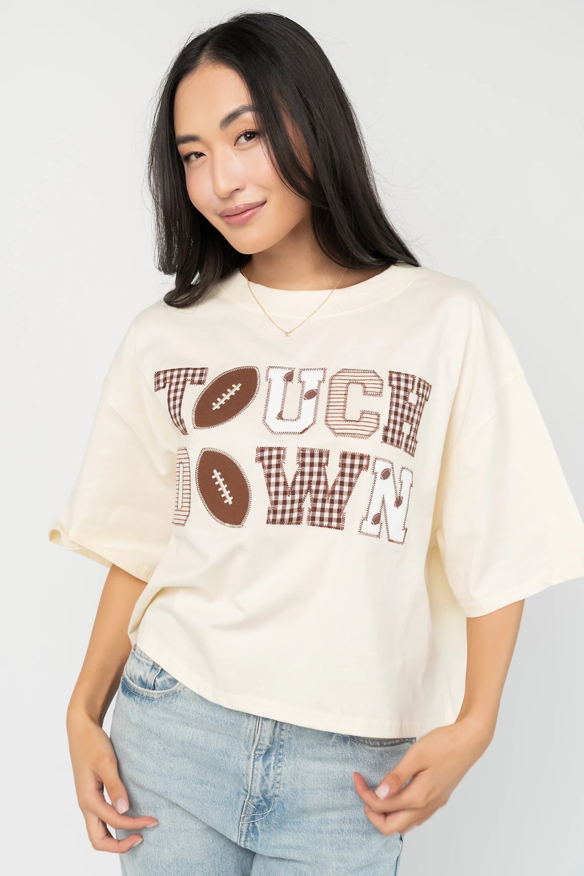 Jason Graphic Tee in Cream with vintage football graphic, gingham, lace and bow appliqué, crew neckline, and short sleeves.