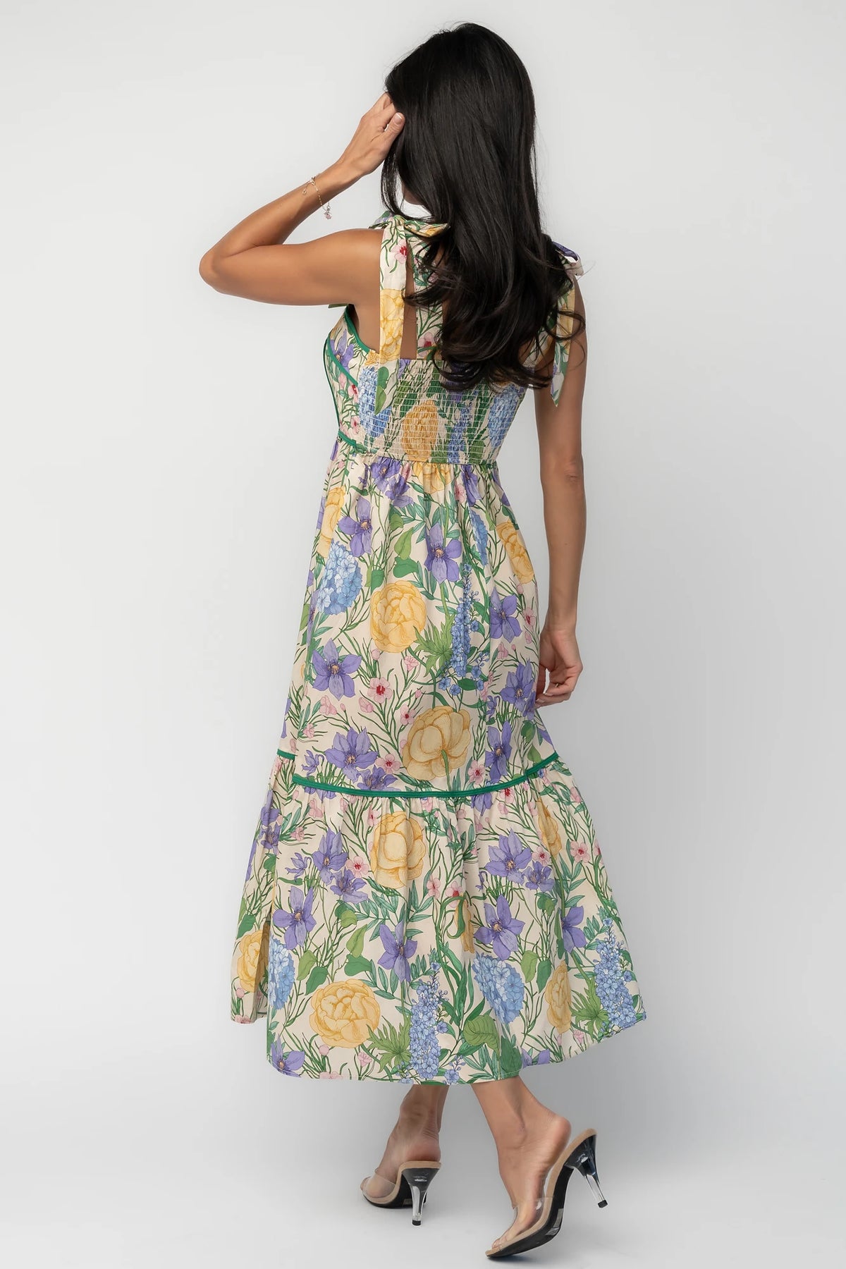 Model wearing the Torres Midi Dress featuring a multicolor floral print with green accents.