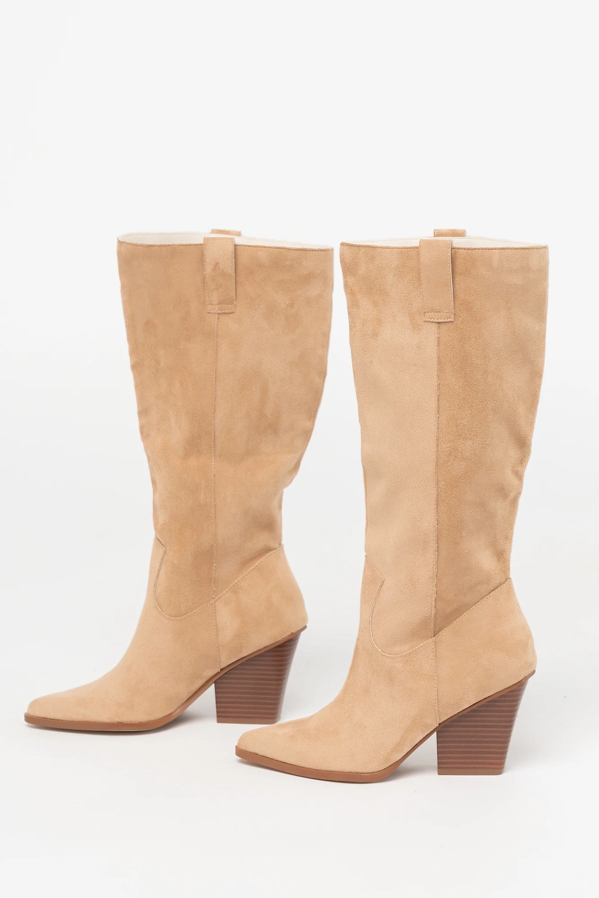 Wren Tall Western Boot in Beige with faux suede finish, pointed toe, angled stacked heel, and pull tab.