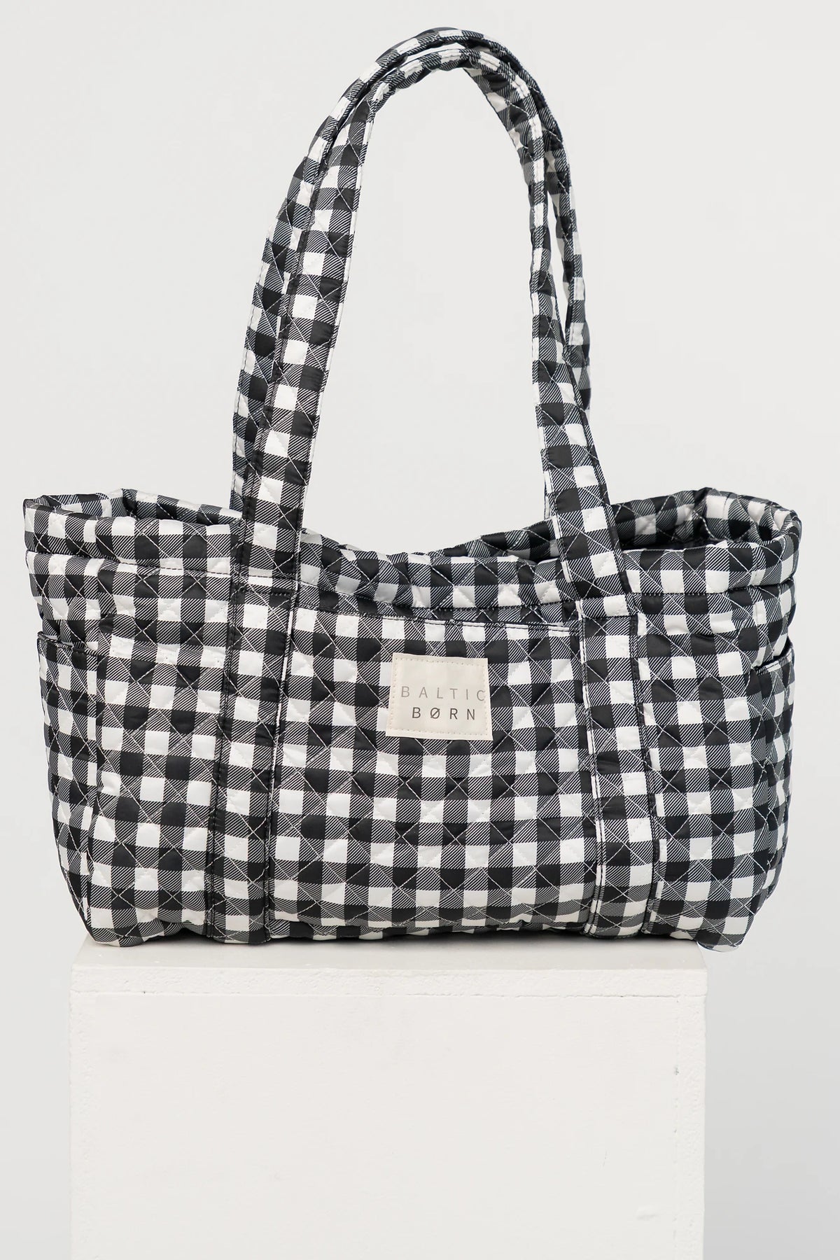 Sedona Gingham Tote Bag in Black with quilted black and white gingham, shoulder straps, snap closure, and interior zip pocket.
