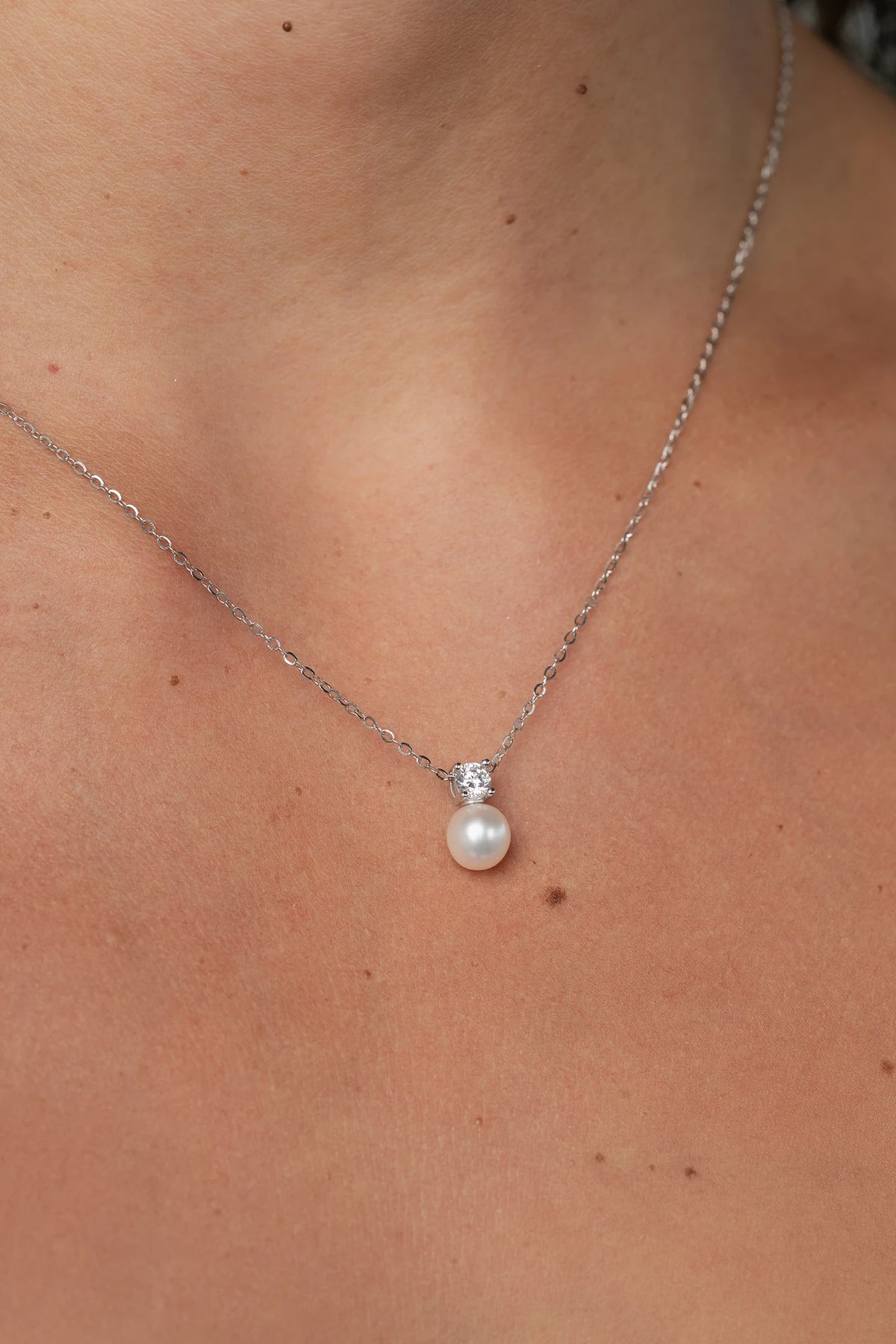 Addilyn Pearl Necklace in Silver with freshwater pearl pendant, moissanite accent, and delicate silver-tone chain.