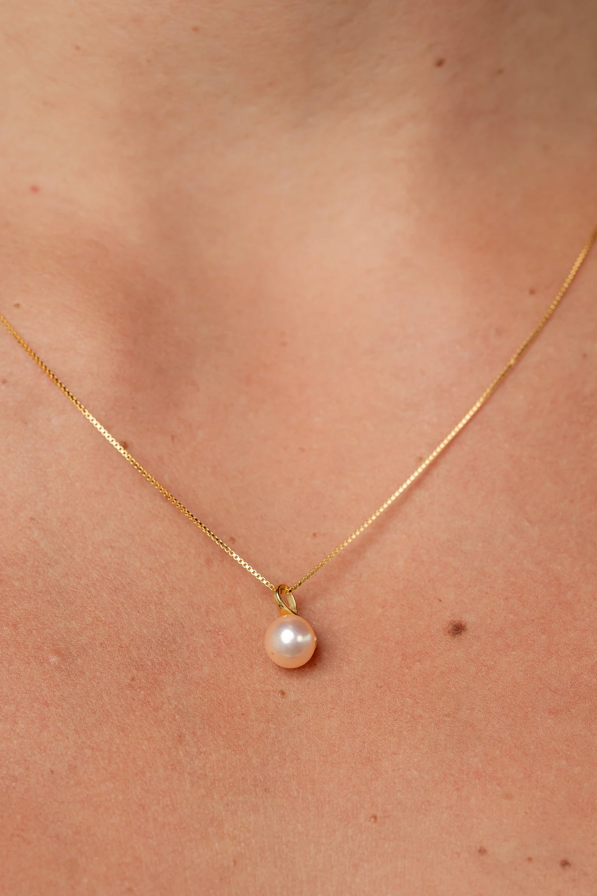 Tanaia Pearl Necklace in Gold with a freshwater light pink pearl and delicate gold-tone chain.