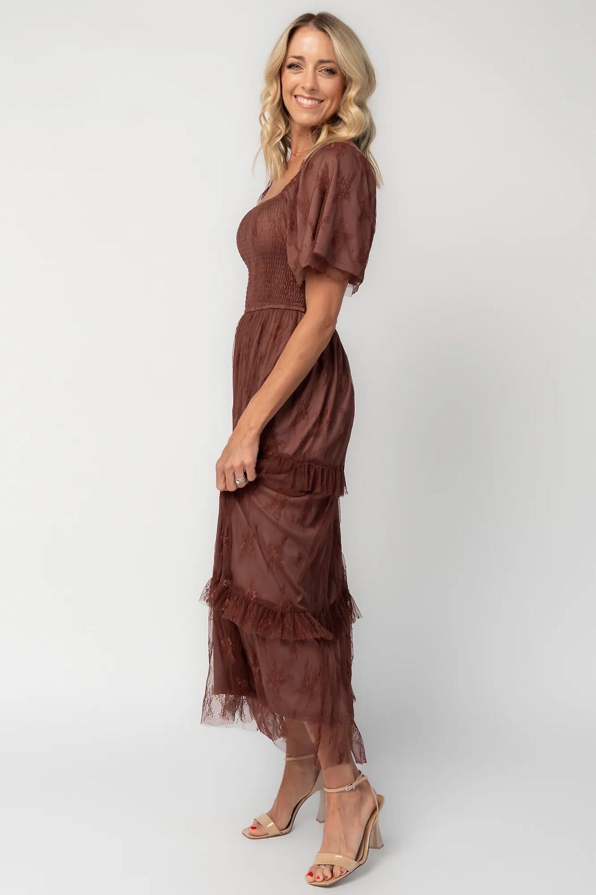 Model wearing a mahogany lace maxi dress with a square neckline, short sleeves, and a smocked bodice.