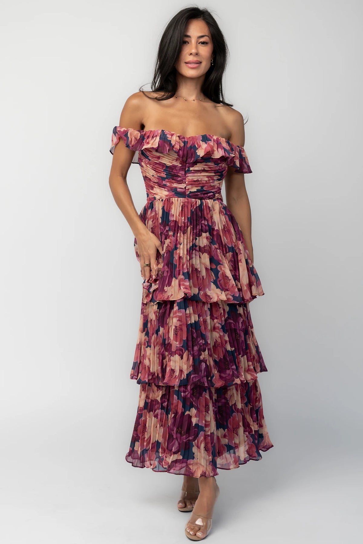 Model wearing the Steinway Pleated Midi Dress in Berry Floral featuring a pink, berry, and mauve floral print on lightweight pleated chiffon.