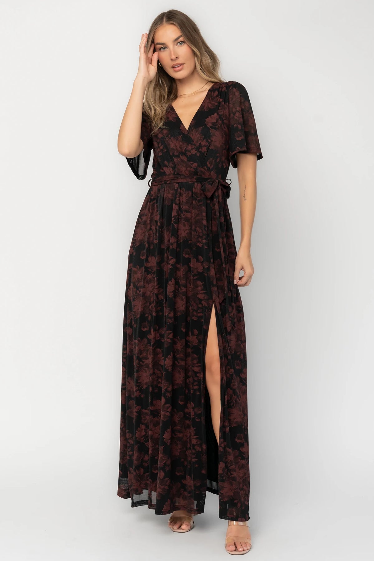 Reverie Maxi Dress in Black + Burgundy with floral print, surplice V-neck, sash waist, long sleeves, and side leg slit.