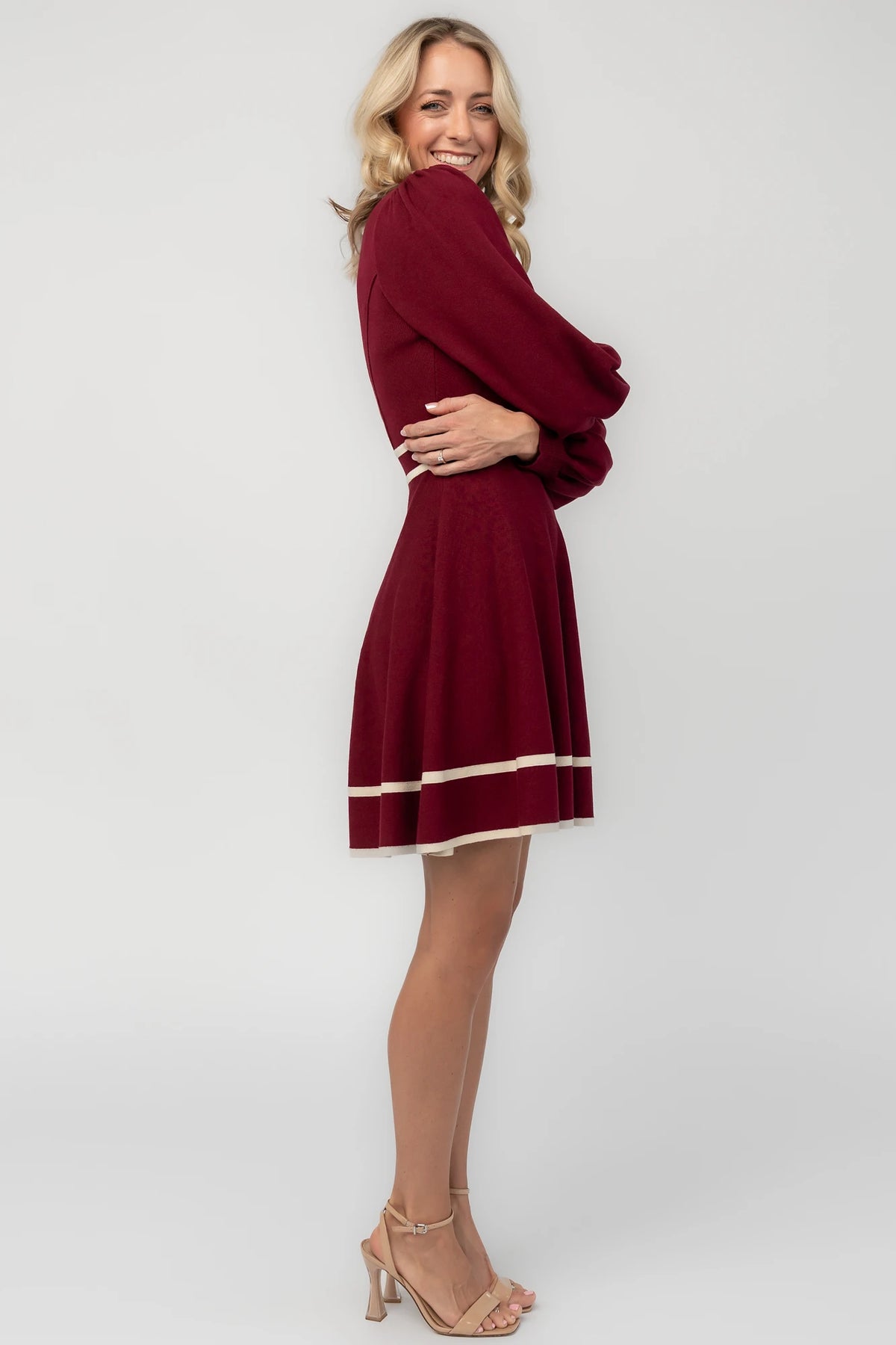 Rich wine knit mini dress with cream contrast trim, long balloon sleeves, a fitted waist, and a flared skirt.
