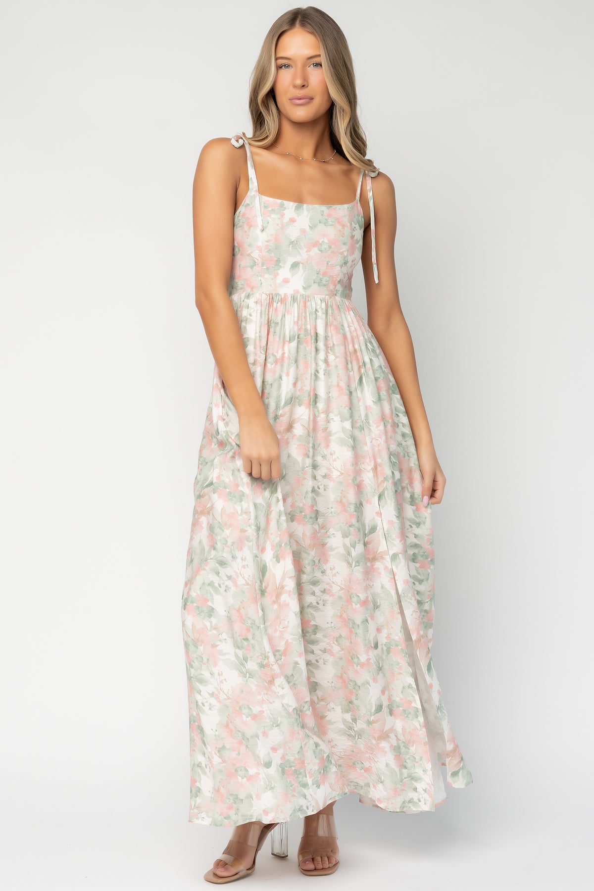 Back view of model in Elton Maxi Dress showing smocked back detail and how the rayon fabric falls from the waist to the flowy hem.