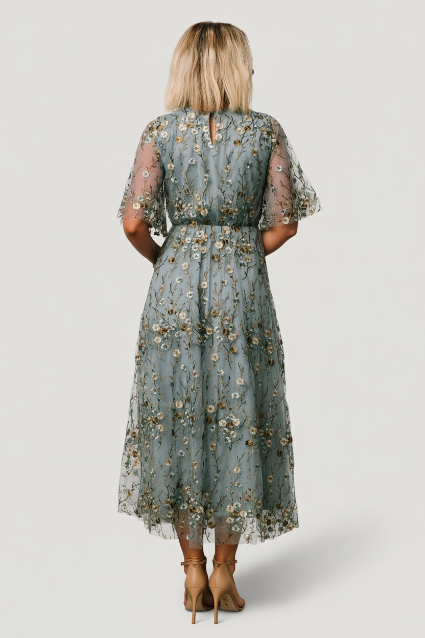 Movement shot of the maxi skirt's extra tulle layer, illustrating the dress's volume, drape, and how it catches light in motion.