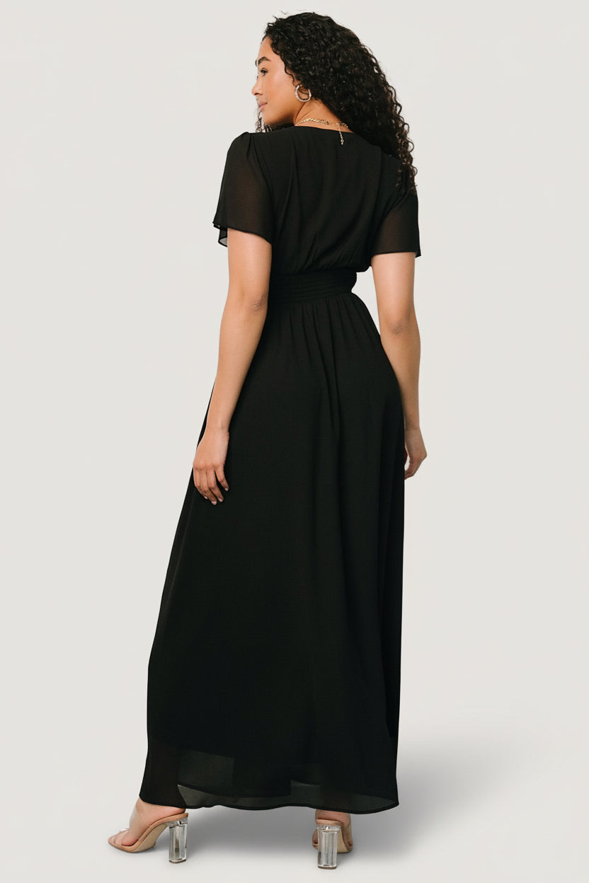 Styled shot of the Birdie Maxi Dress in black paired with simple accessories, emphasizing its versatility for formal and casual events.