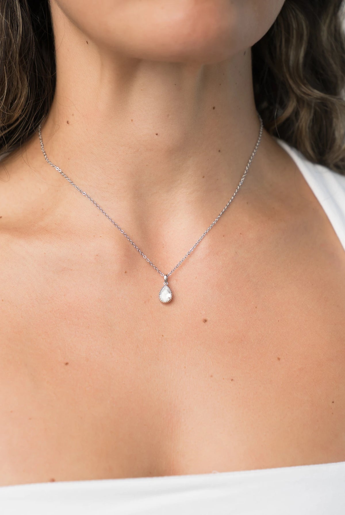 Christy Teardrop Pendant Necklace in Silver with teardrop cubic zirconia pendant and delicate chain.