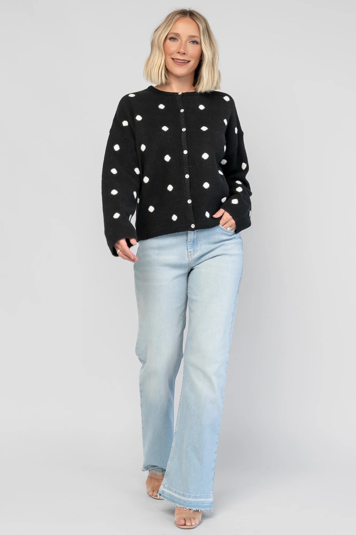 Cinder Cardigan in Black + White Dot with a button-front closure, polka-dot trim, and a relaxed knit silhouette.