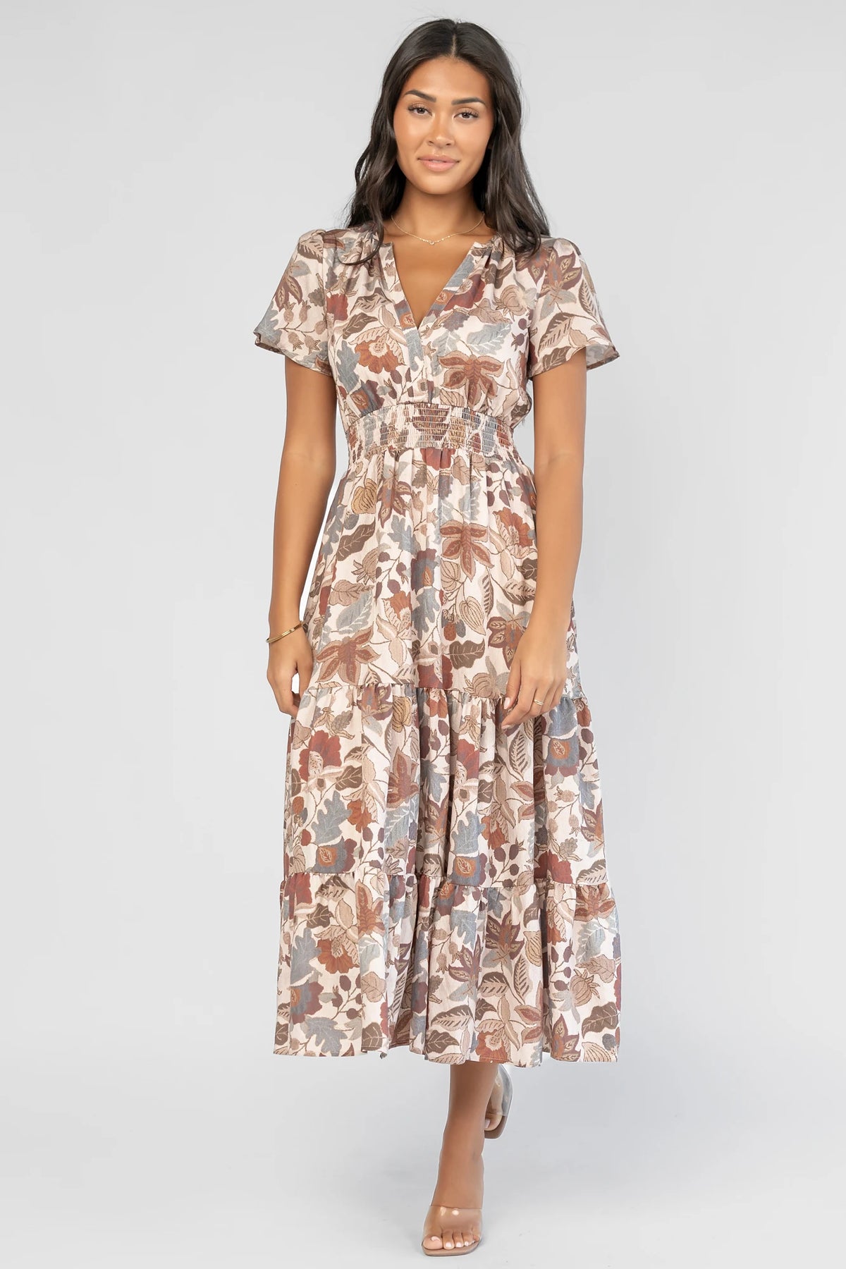 Holland Dress in Taupe Multi with a smocked waist, V-neckline, flutter sleeves, and a floral print.