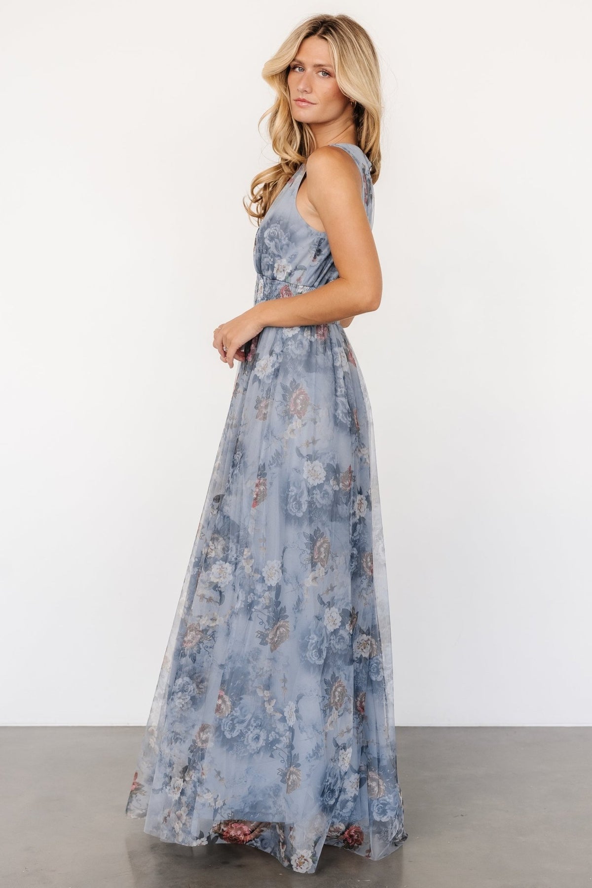 Detail image of layered tulle and floral pattern on dusty blue fabric, emphasizing the lightweight drape and lined construction.