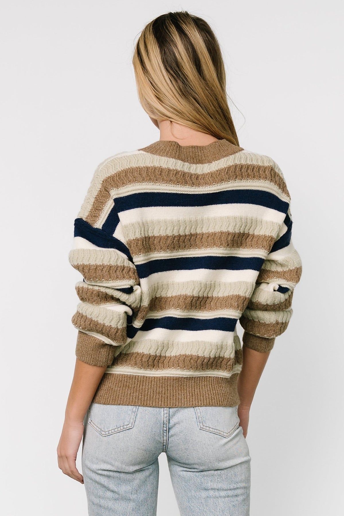 Styled outfit view featuring the Kira Striped Sweater paired with casual bottoms, showing drape and versatile length for layering.