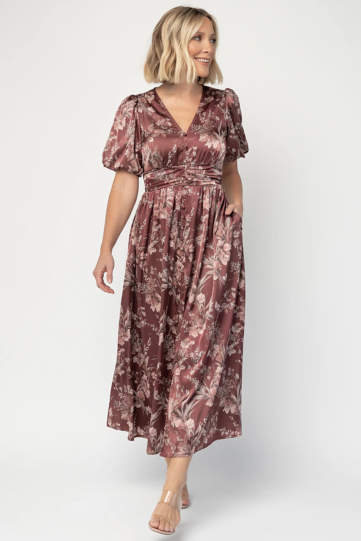 Lilibet Satin Dress in Clove Floral with V-neckline, short sleeves, faux front buttons, gathered waist, and satin finish.