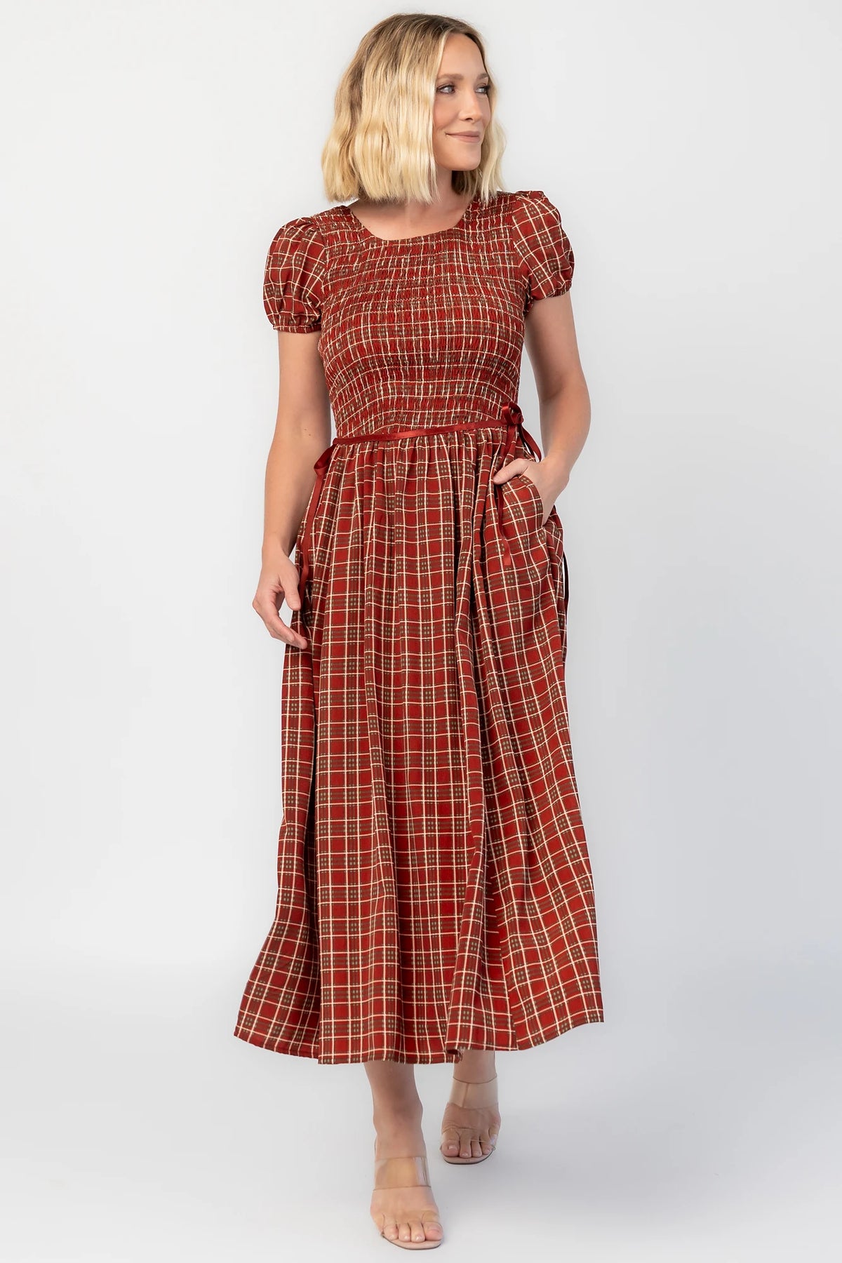 Lorelei Smocked Dress in Red Print with round neckline, smocked bodice, and elastic sleeves.