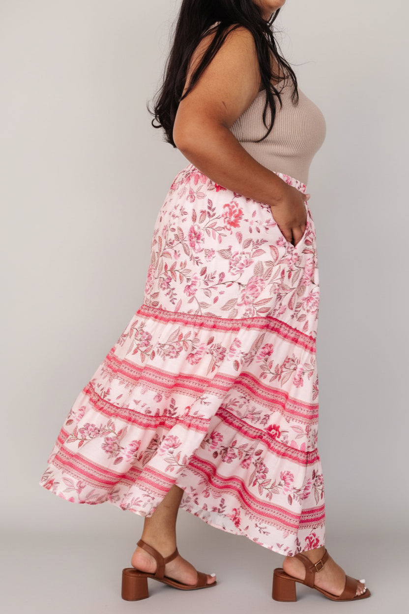 Back and movement view of Meg tiered midi skirt in blush multi, showing fit at the waist, flow of tiers, and how the fabric falls on the body.