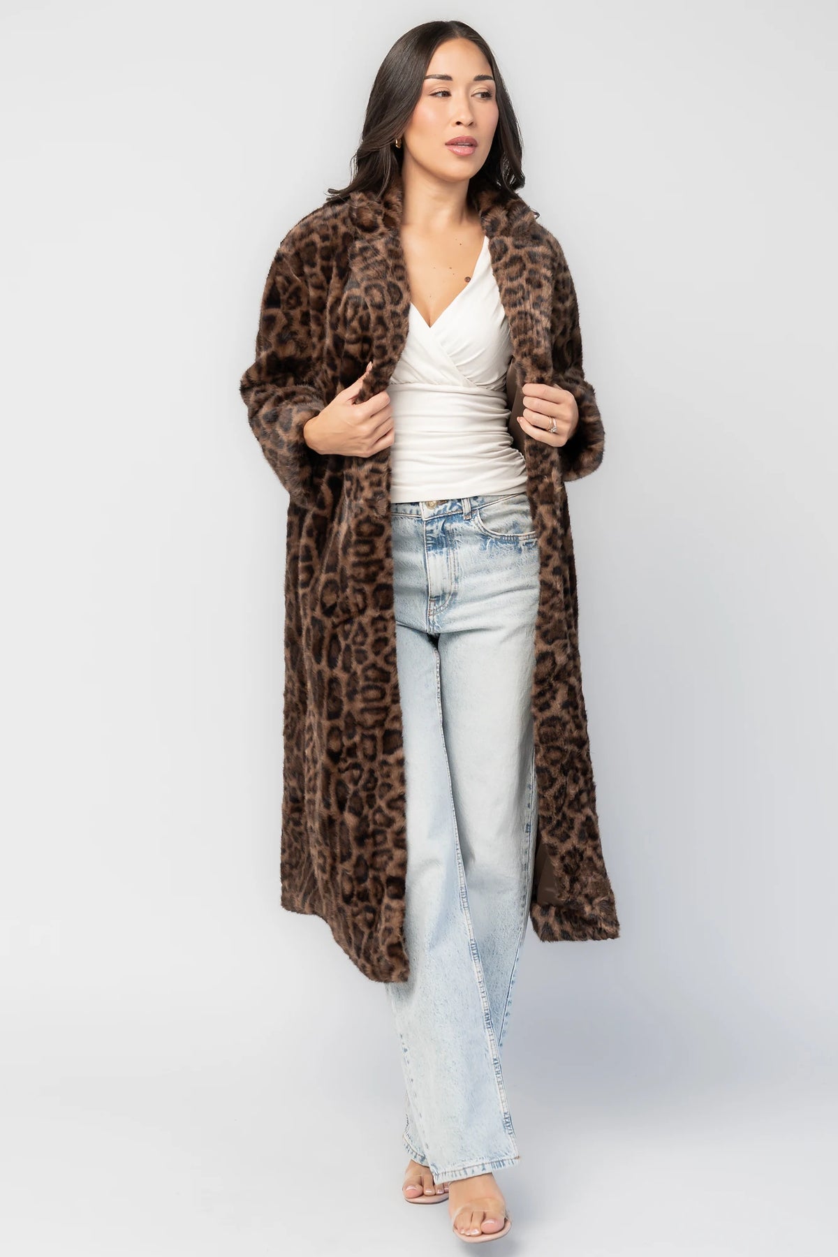 Novalie Coat in Brown Leopard Print with plush faux fur texture, notched collar, long sleeves, and longline silhouette.