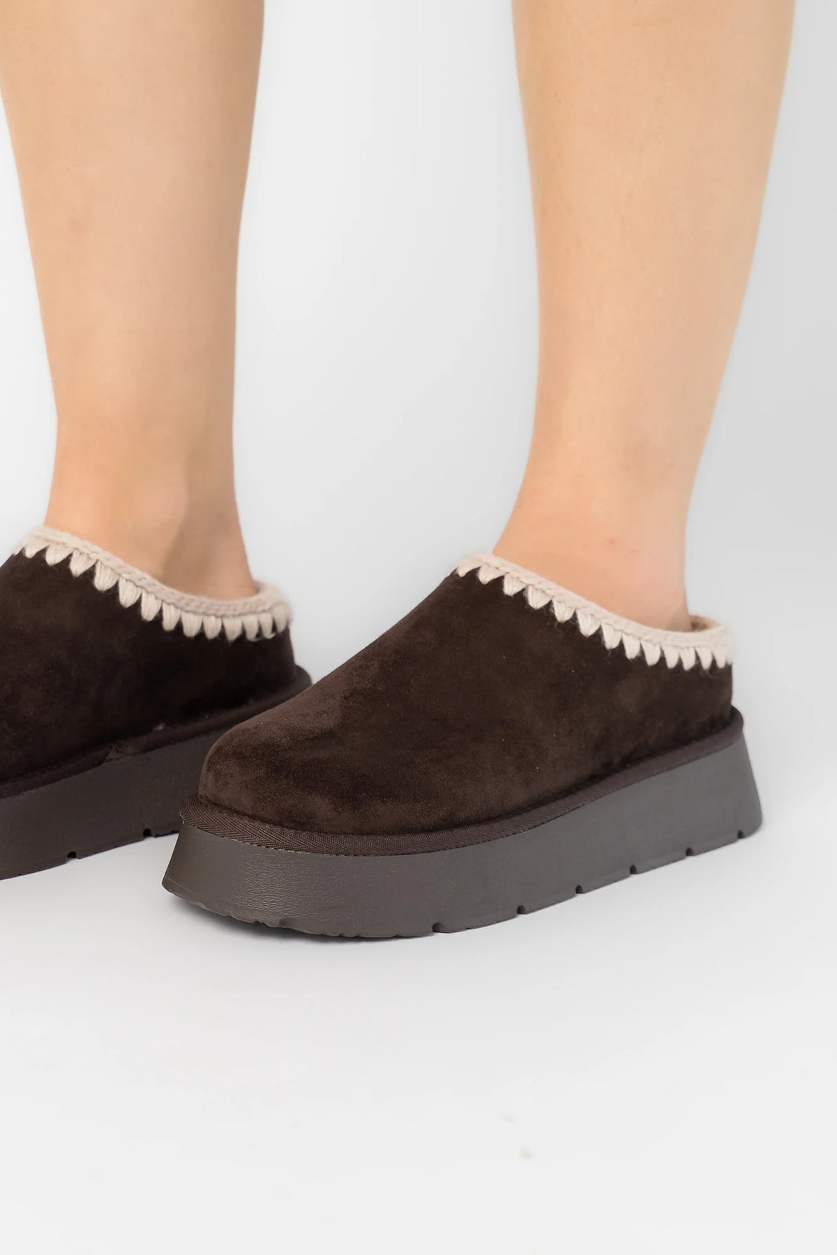 Pamela Platform Cozy Mule Slippers in Chocolate with faux suede, plush lining, whipstitch trim, and platform sole.