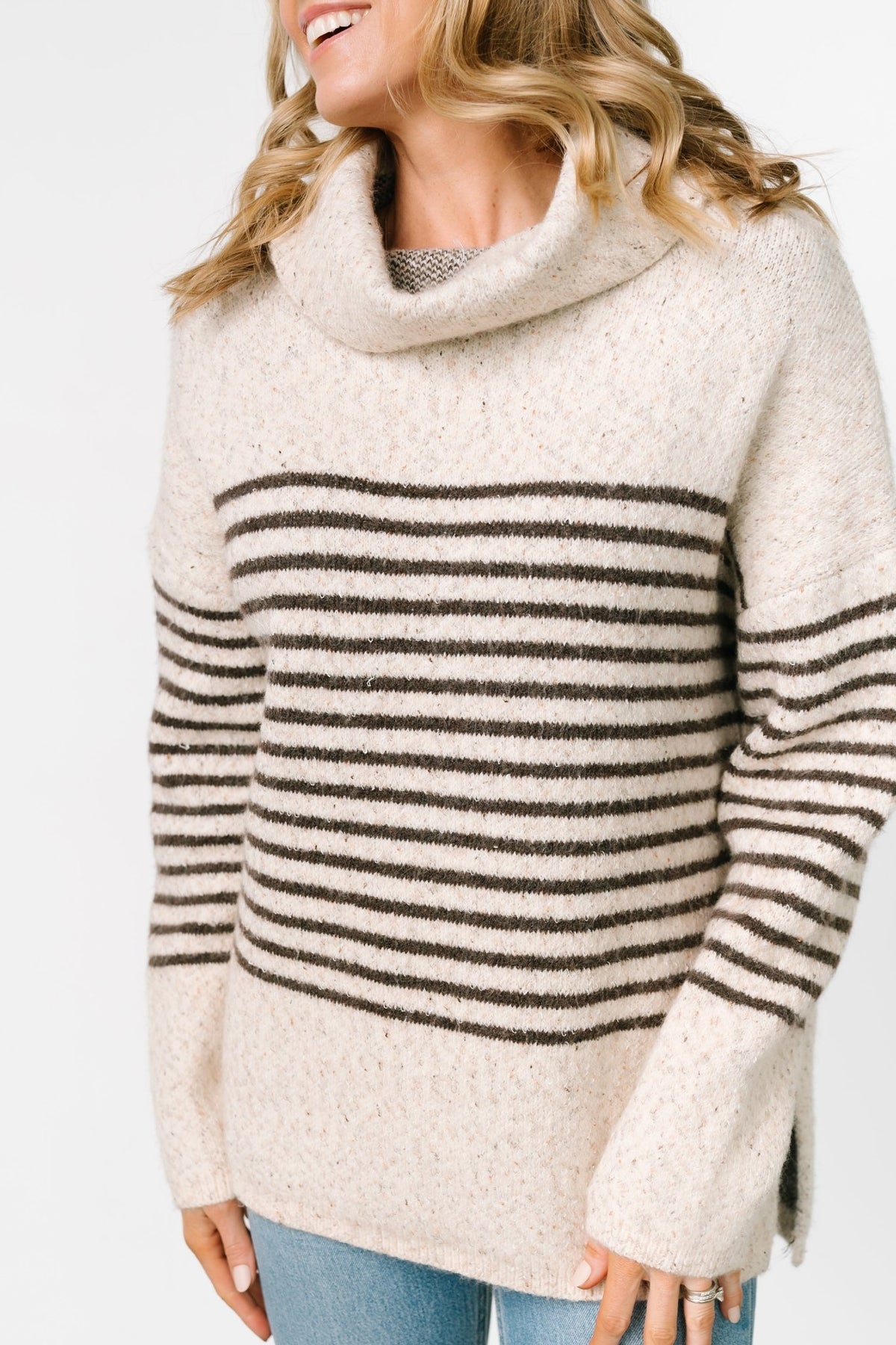 Front model view of Pennington turtleneck sweater in speckled cream with dark multi-stripes, ribbed cuffs and split side hem.