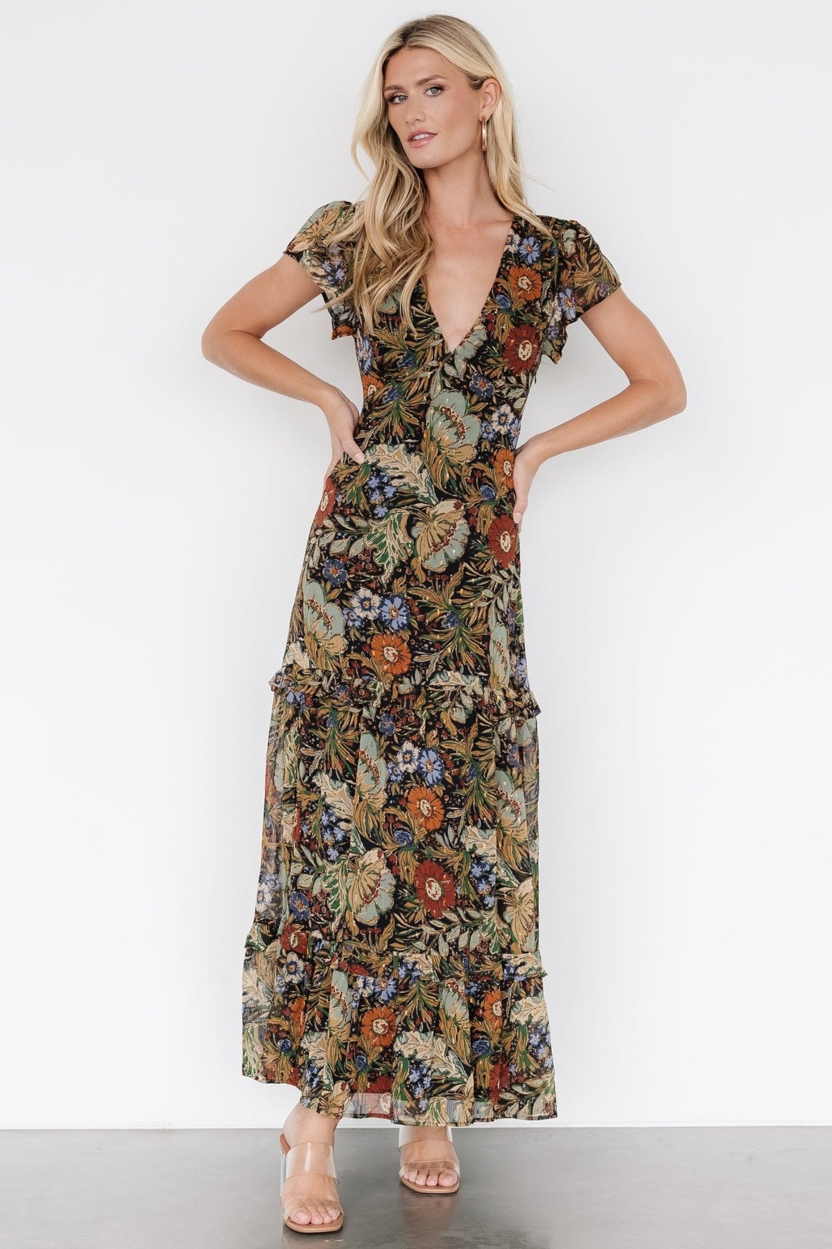 Model wearing the maxi dress in a front pose, showing overall fit, length, ruffle tiers, and graceful movement.