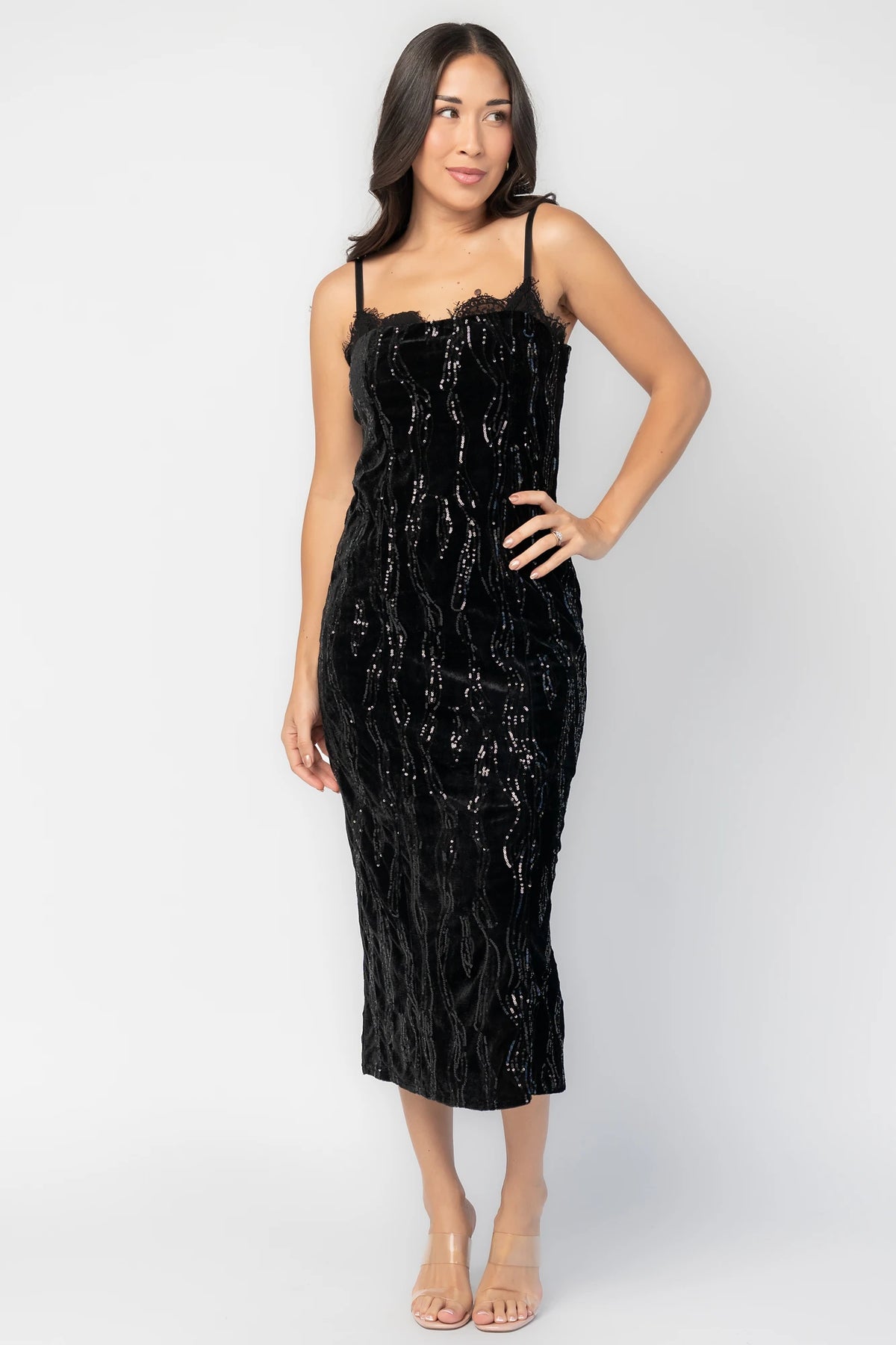 Sabina Sequin Midi Dress in Black with allover sequins, black lace neckline, spaghetti straps, and fitted silhouette.