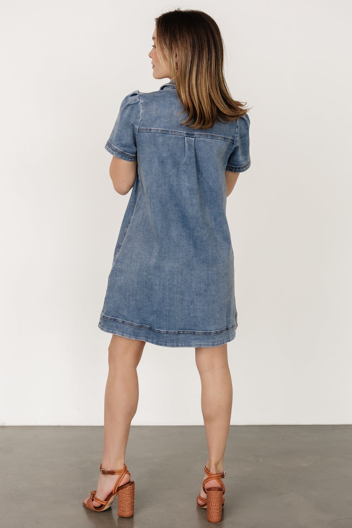 Back and full-length view of the Saylor short denim dress on model, showing straight hem and relaxed pull-over design.