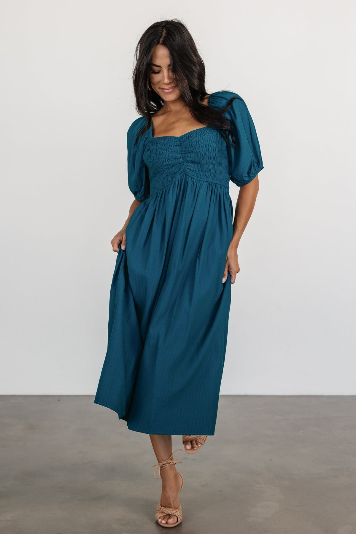Styled outfit shot of Stefania Midi Dress in Mediterranean Blue paired with minimal accessories to show versatility for daytime and event wear.