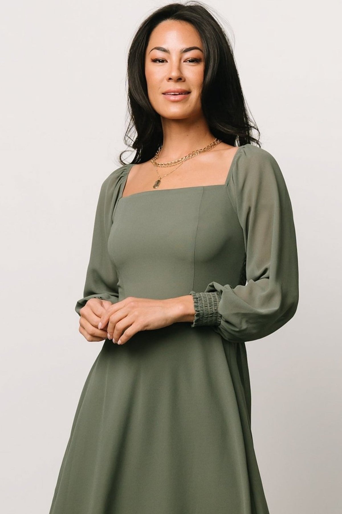 Single dark sage chiffon swatch laid flat to display fabric drape, semi-sheer texture, and color depth for bridesmaid coordination and comparison.