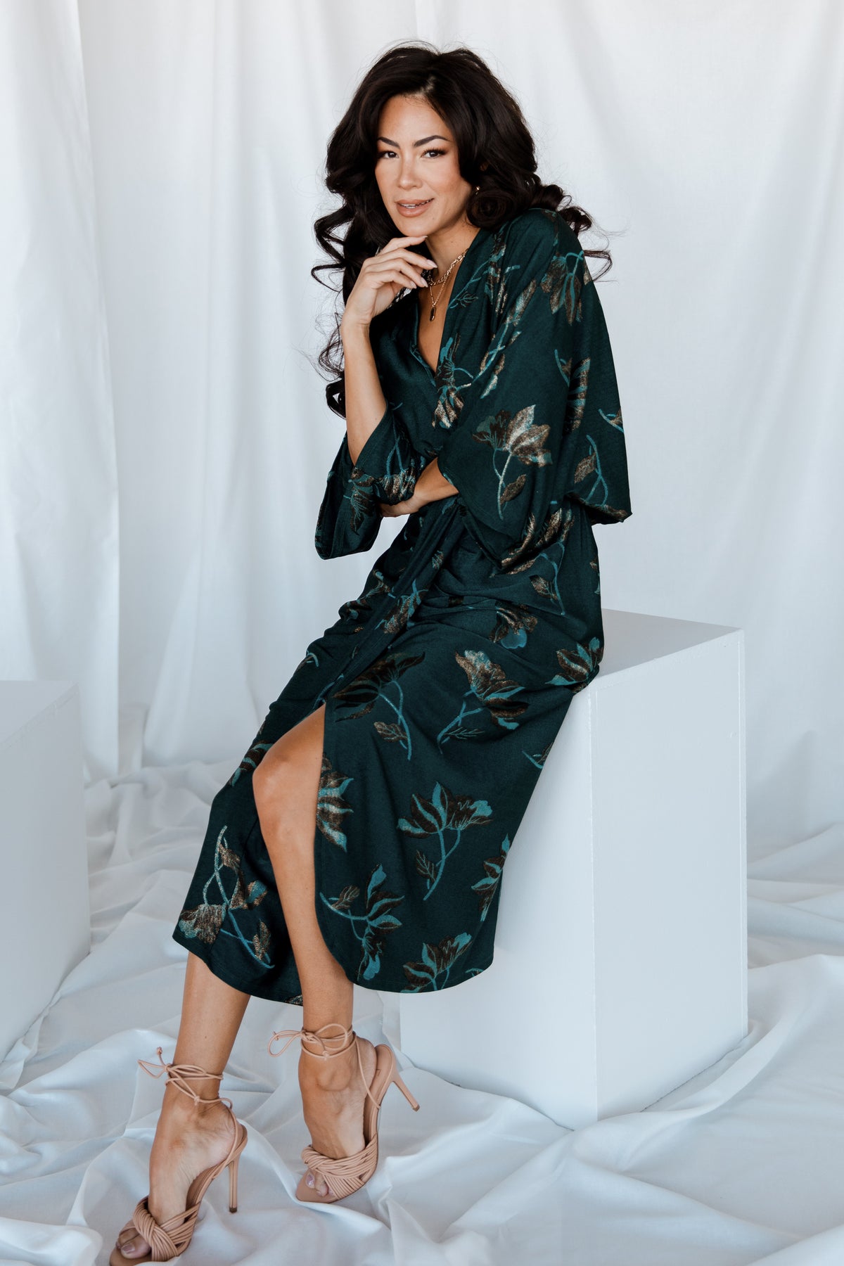 Side view of the ruched midi dress displaying the elastic natural waist, gathering at the waist and the modest front slit.