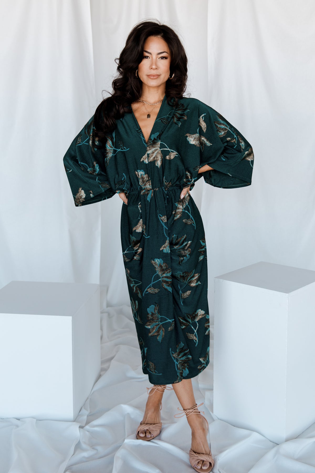 Three-quarter view of the jade floral shimmer Shaneen midi dress highlighting elbow-length dolman sleeves and subtle metallic sheen.