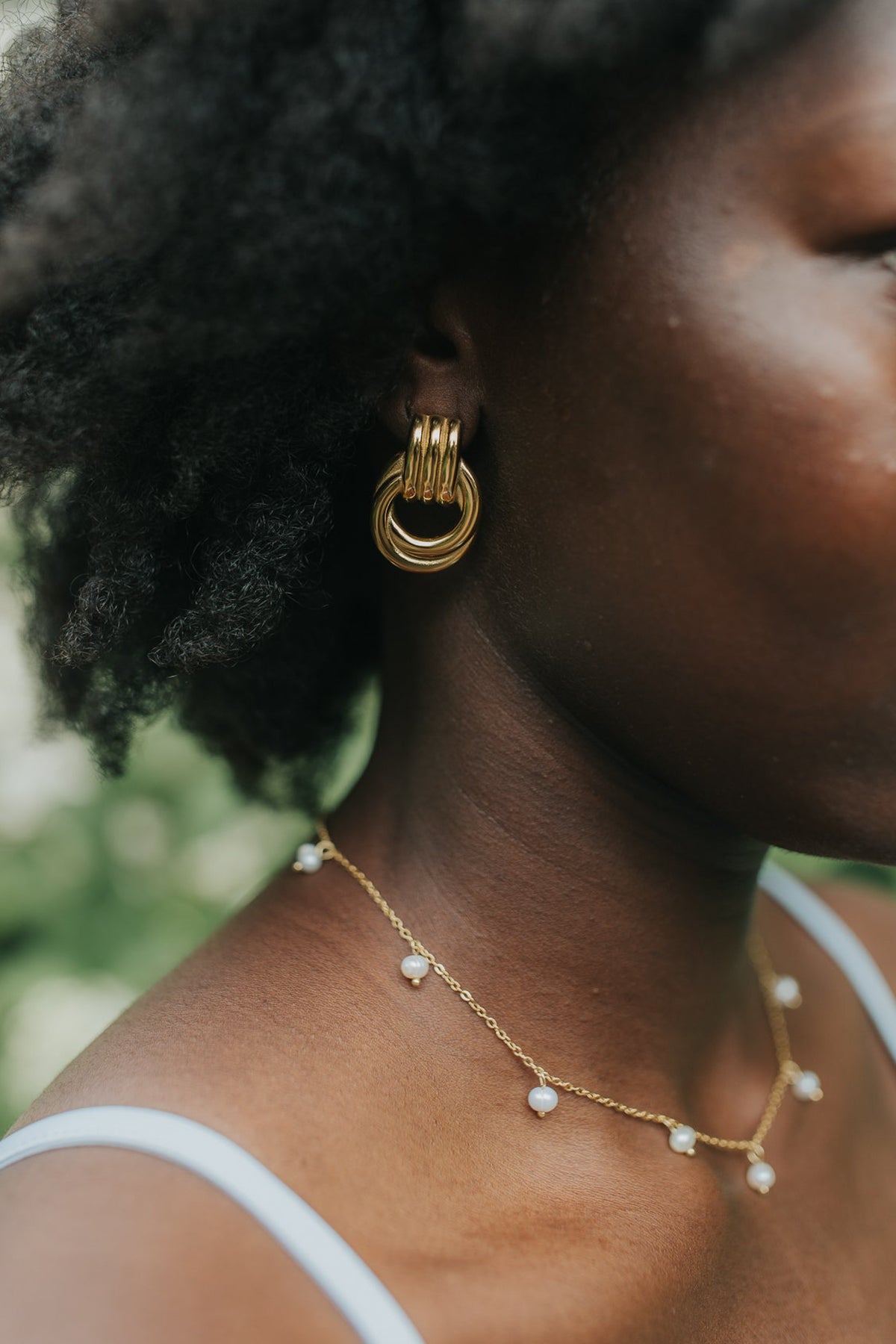 Model wearing The Rosie Pearl Necklace at collarbone length to show drape, pearl spacing, and the necklace's lightweight, feminine profile.
