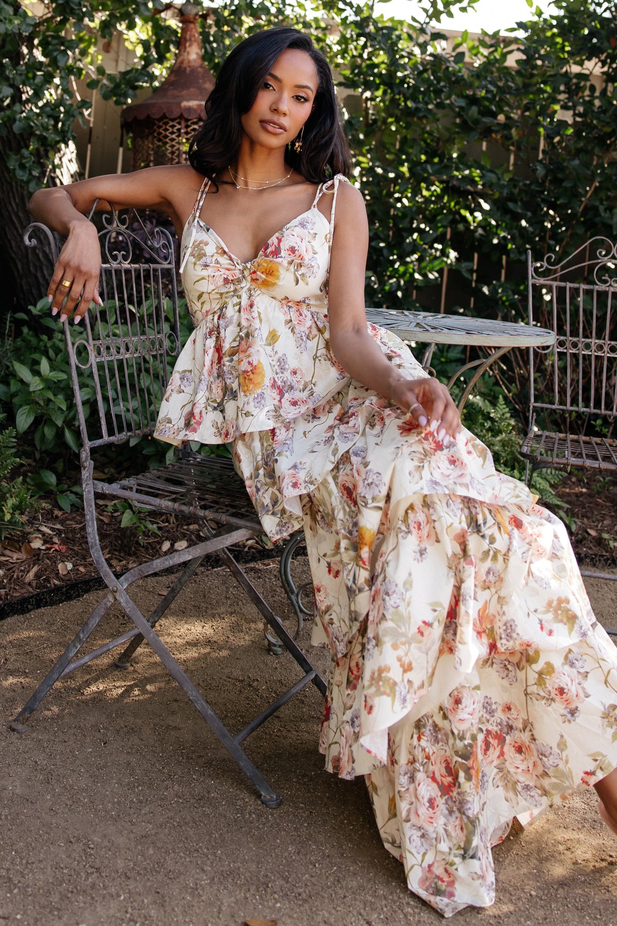 Model walking in the Angelica Tiered Maxi Dress, showing movement of tiers and a flattering, flowy silhouette in a buttercream floral pattern.