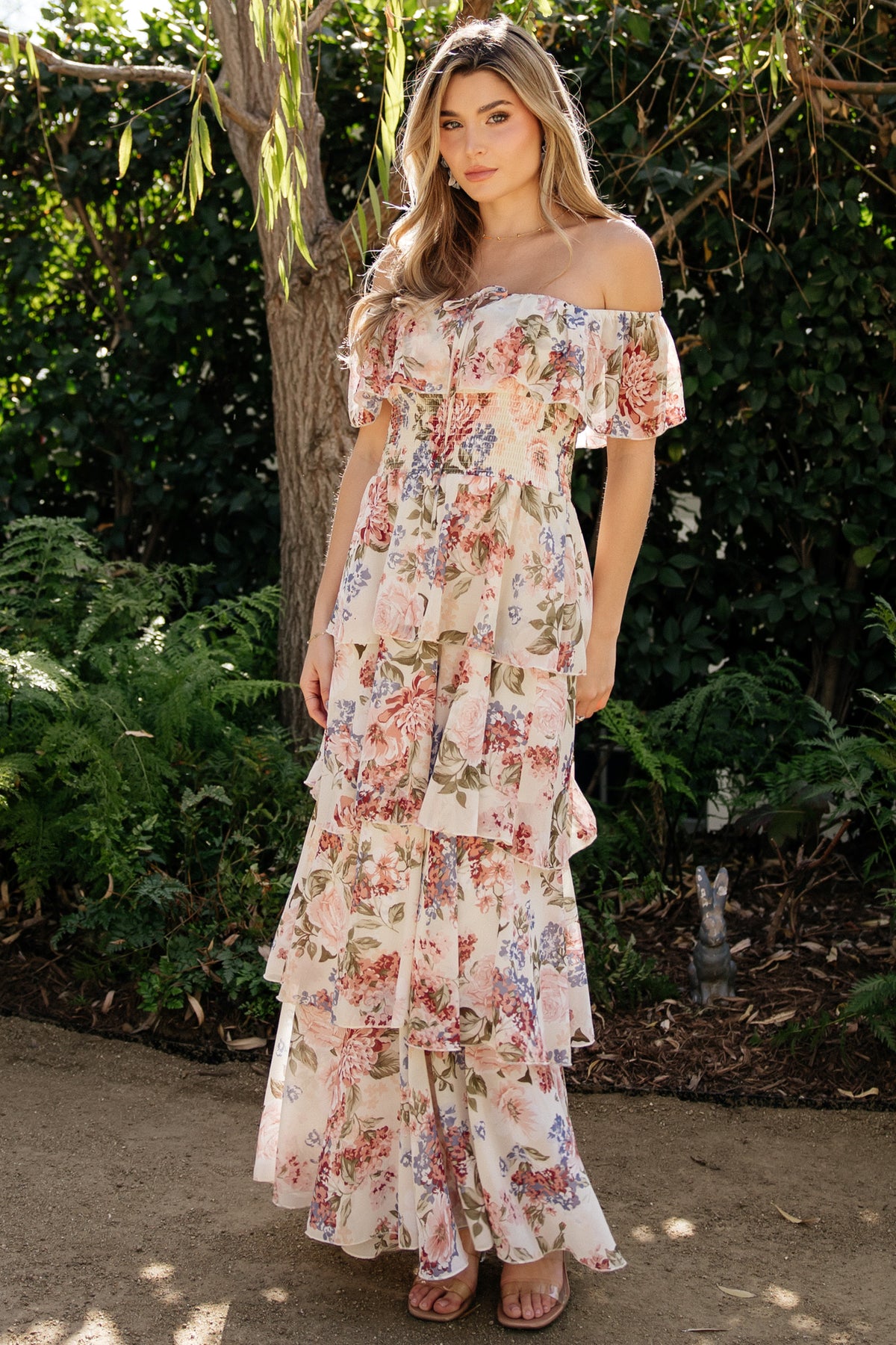 Front view of multi floral chiffon maxi dress with off-shoulder elastic neckline, smocked waist and four-tiered flowing skirt, fully lined.
