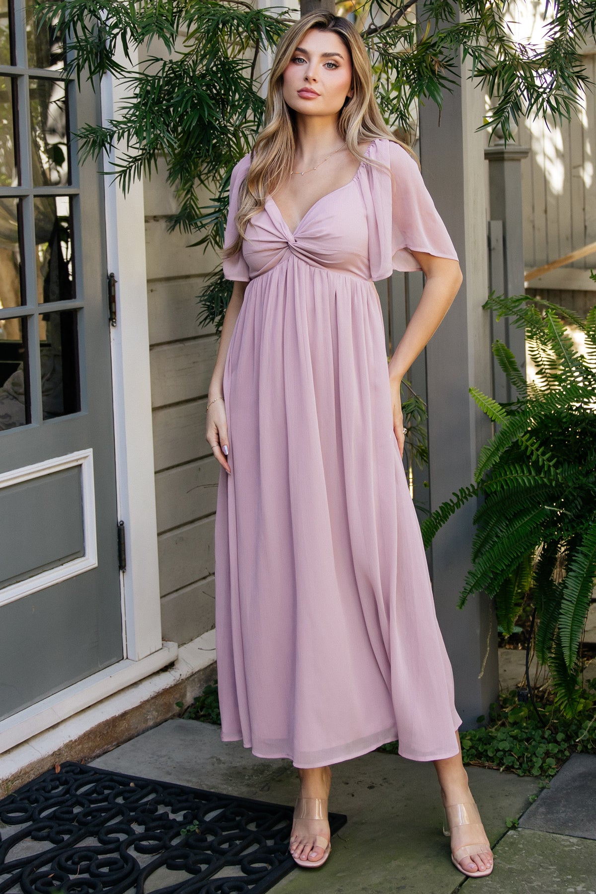 Front view of Nora Midi Dress in dusty mauve on model, showing sweetheart neckline, knotted bust, and flowing midi skirt with soft drape.