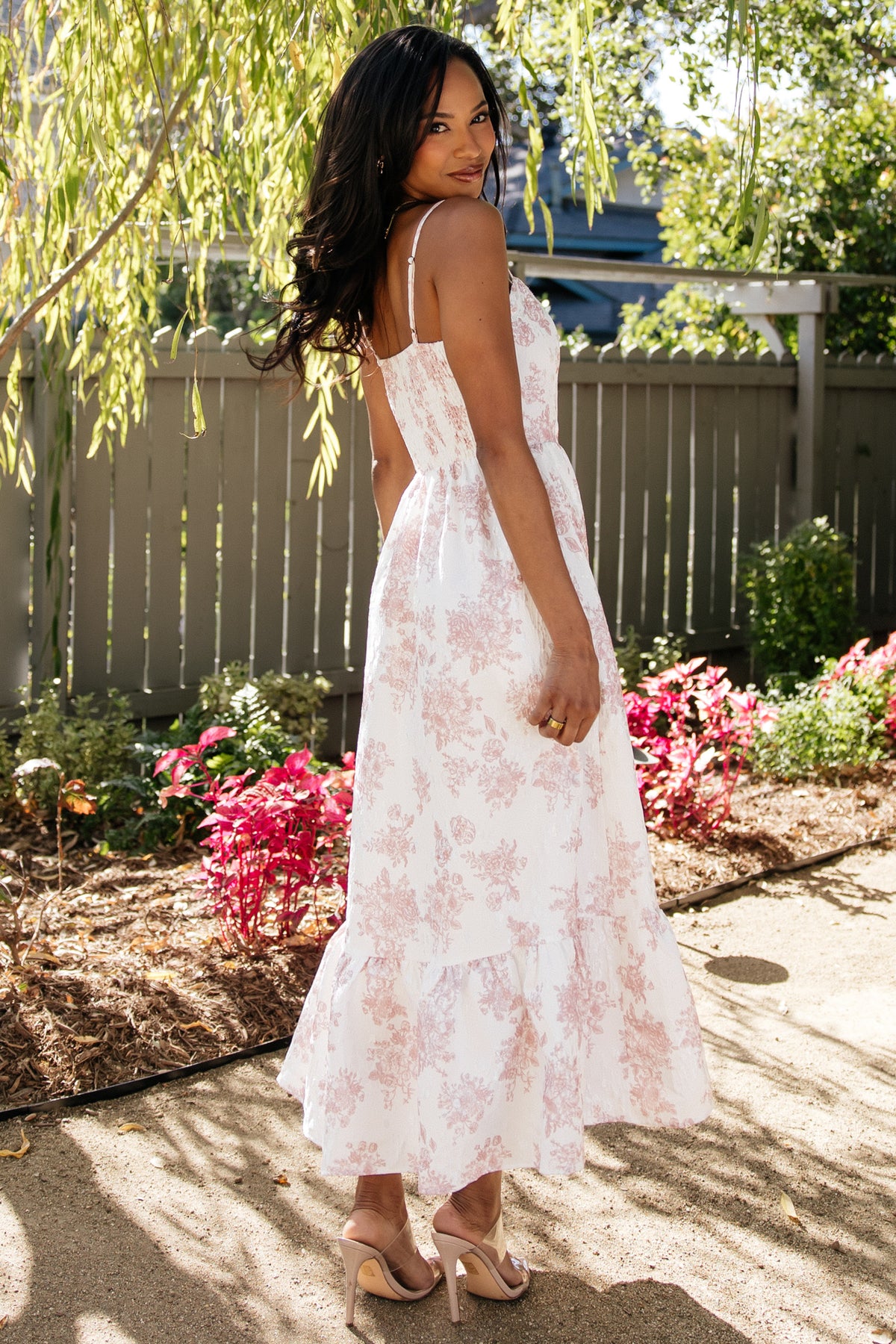 Close-up of jacquard weave and pink floral pattern on textured off-white fabric, showing intricate woven detailing.