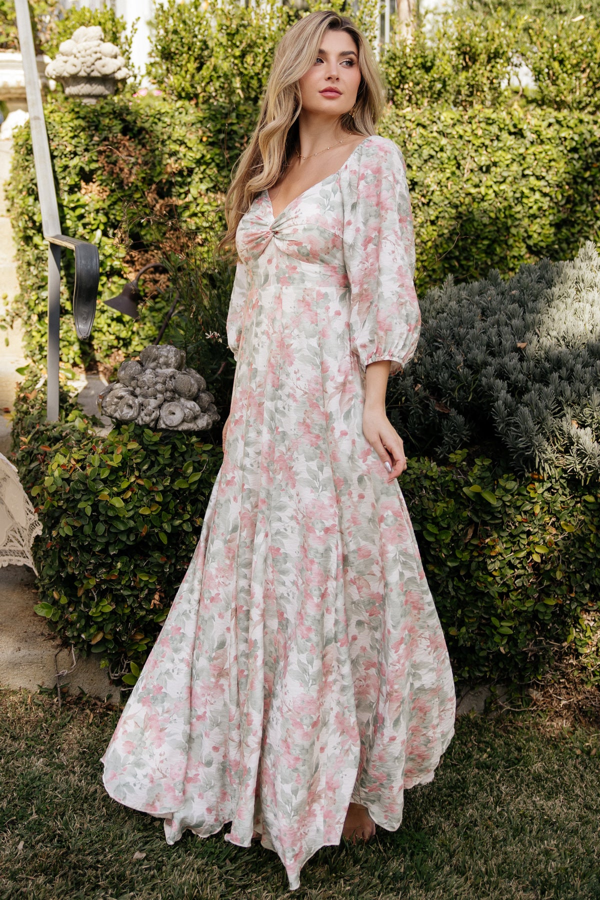 Close-up of fabric and floral pattern on the Esther Maxi Dress, highlighting dusty-pink and green florals on a sage base and lightweight polyester weave.
