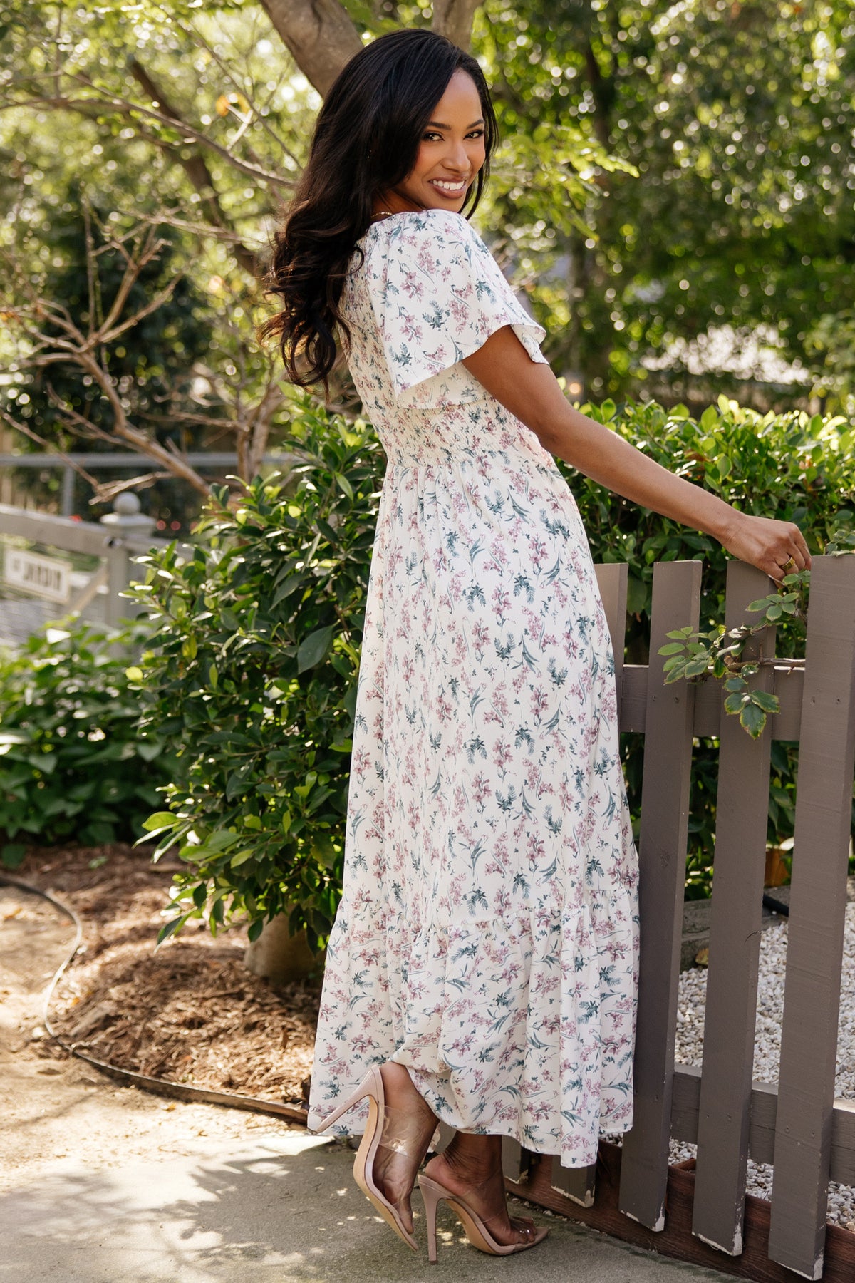 Detail shot of the skirt tier and hem on the Joanie dress, emphasizing the lightweight rayon drape and soft cream multi floral pattern.