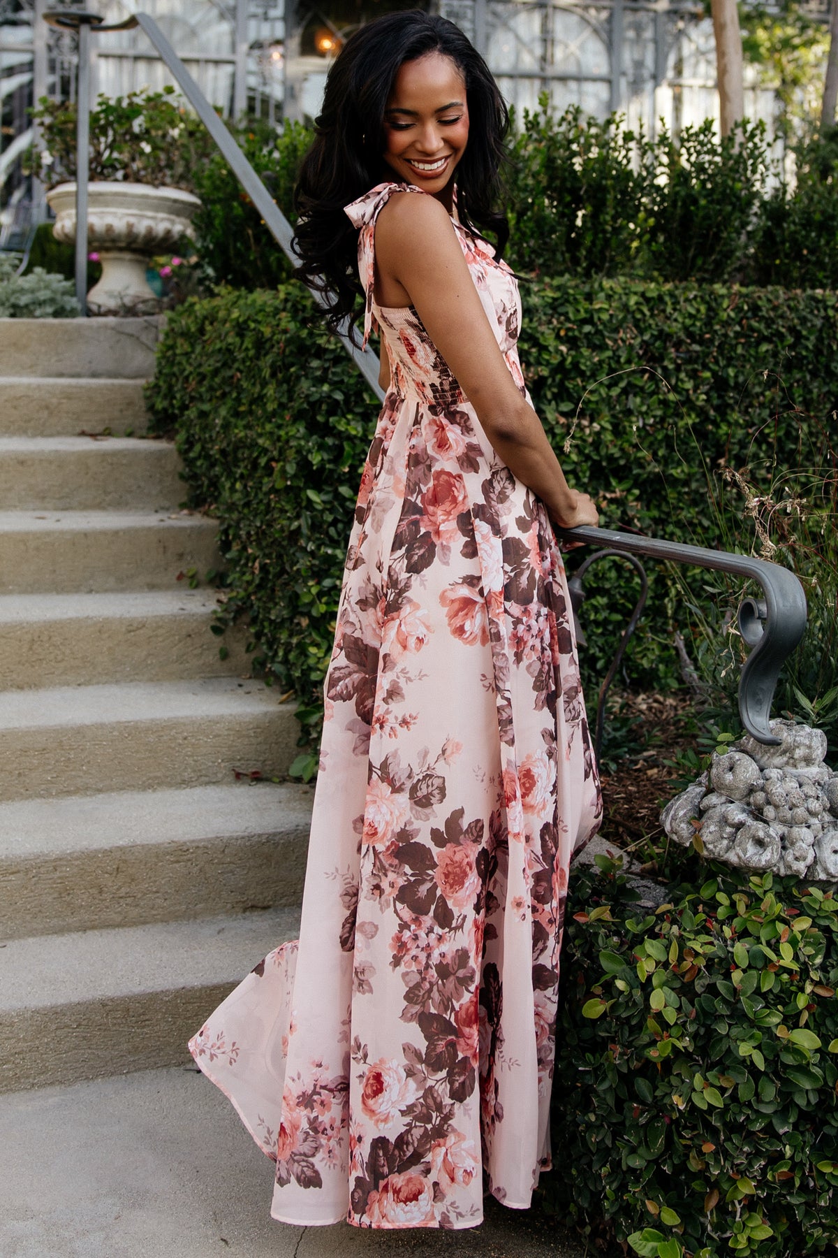 Back view of Macey Maxi Dress showing smocked back, full lining, and the pink multi-floral print across the maxi silhouette.