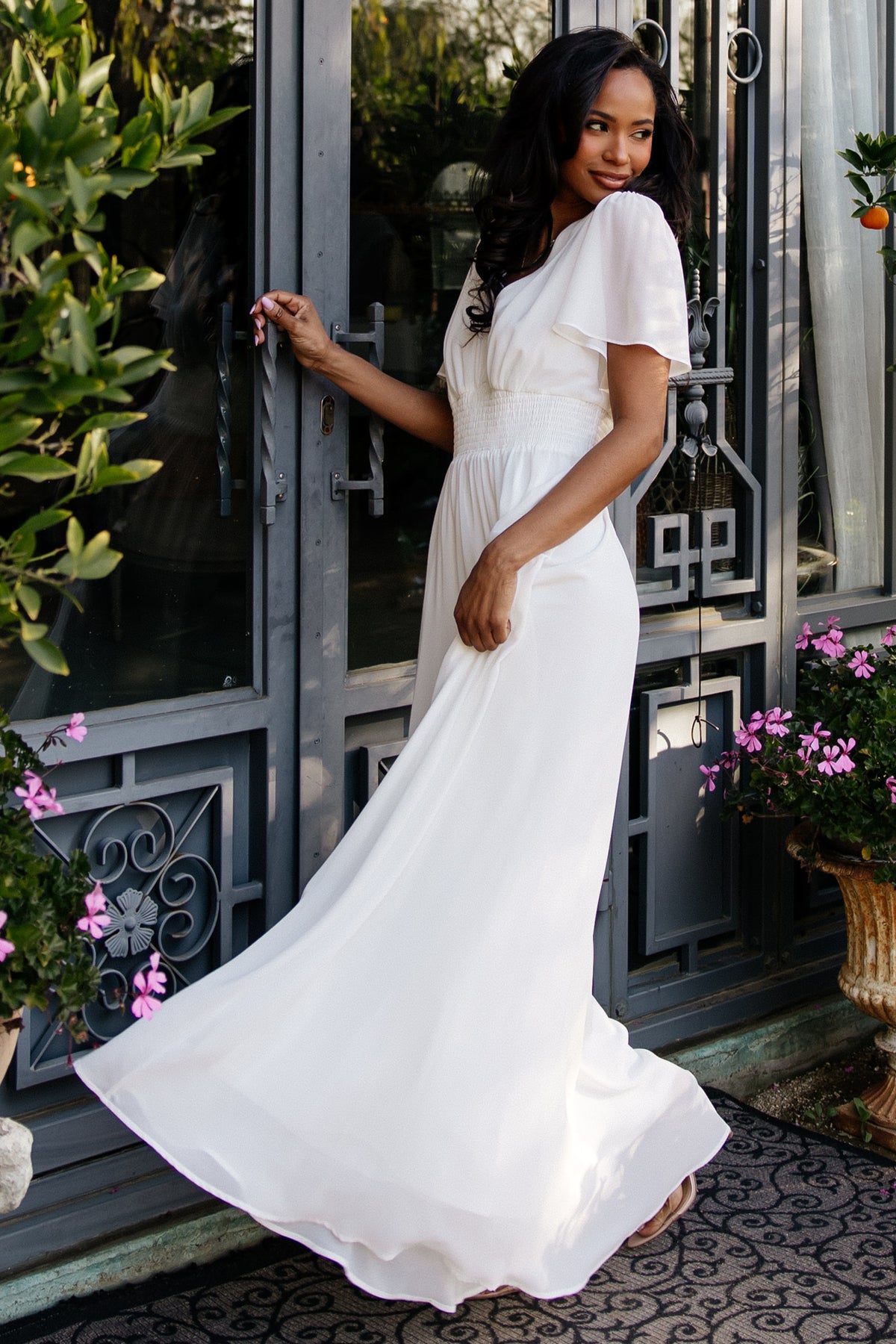Back view of the Birdie Chiffon Maxi Dress in white showing relaxed fit through bodice, back seam detail and graceful skirt fall.