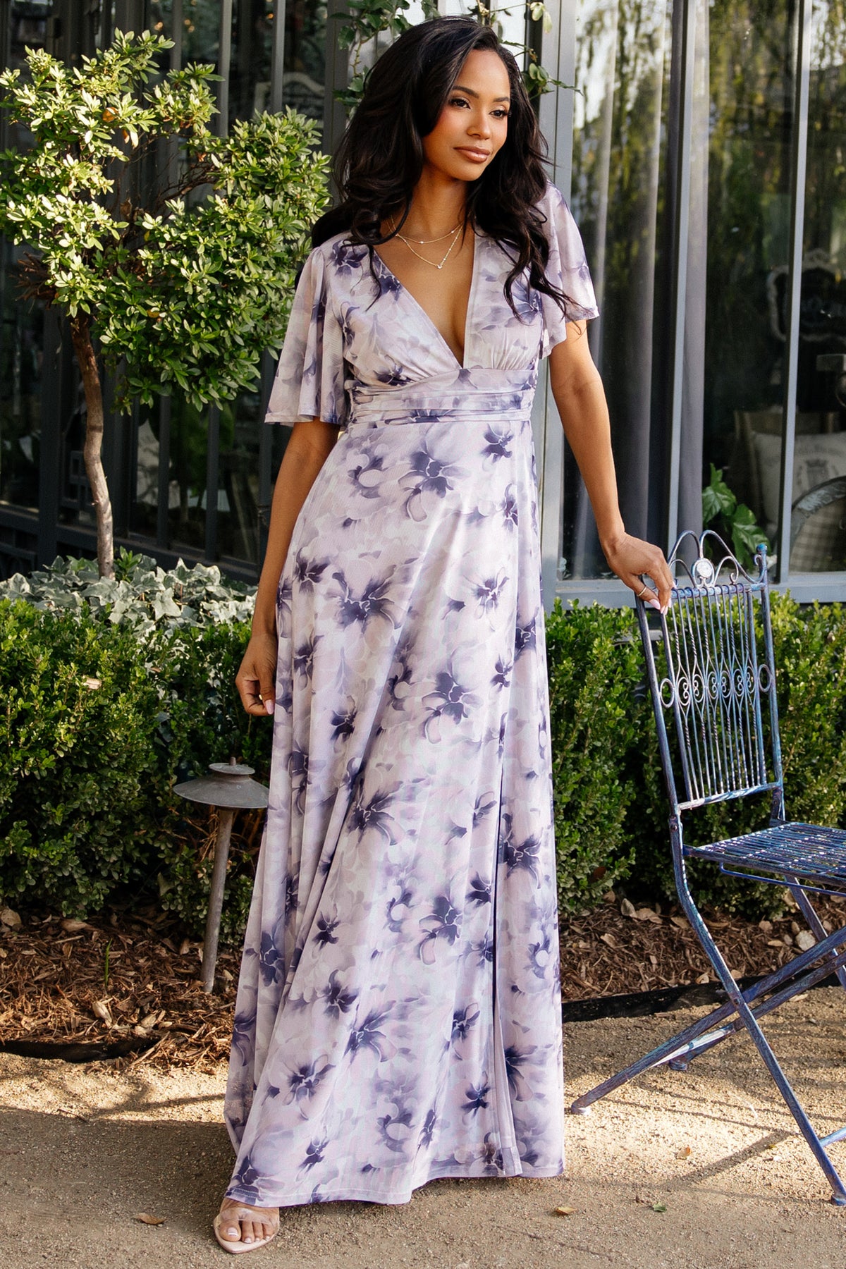 Close-up of dusty lavender floral print on stretch mesh with pleated bust detail and subtle texture of the sheer sleeve overlay.
