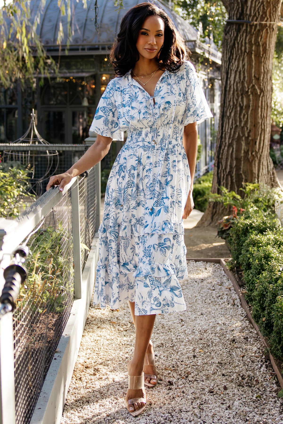 Three-quarter view of Willow Boho Midi Dress highlighting subtle gathered shoulder yoke, short sleeves, and the tiered ruffle midi skirt silhouette.