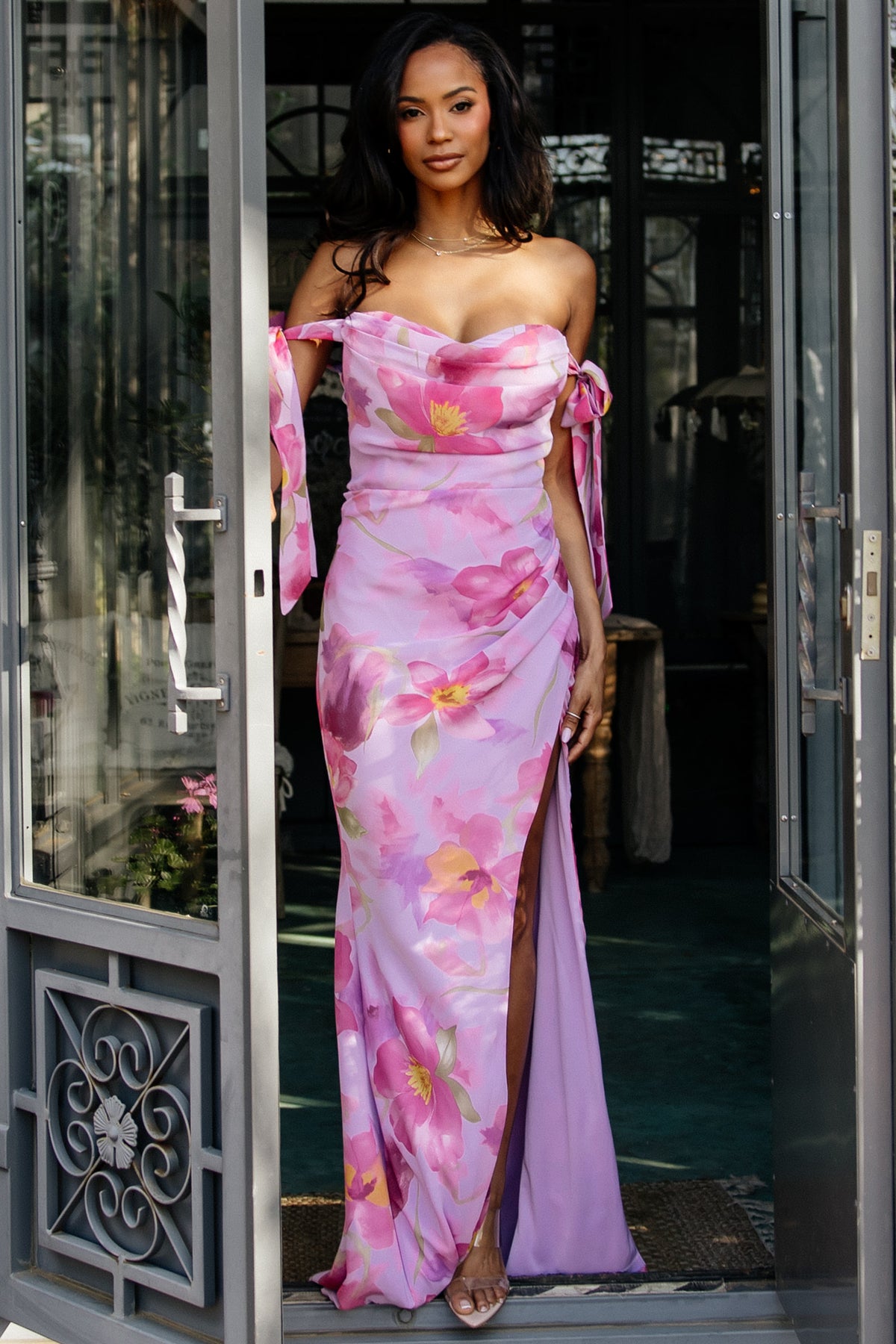 Three-quarter view of dress movement, showing tulip skirt panels and lavender floral print in soft chiffon fabric.
