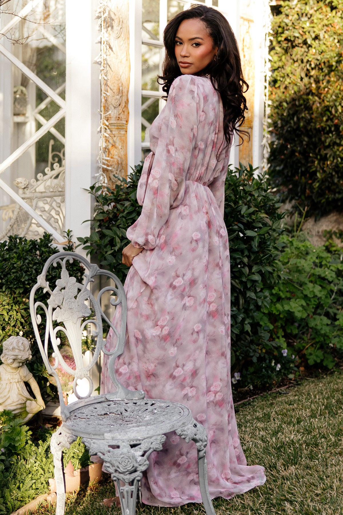 Movement shot: model walking in Ensley Maxi Dress Dusty Rose Floral, full skirt swaying from chiffon fabric.