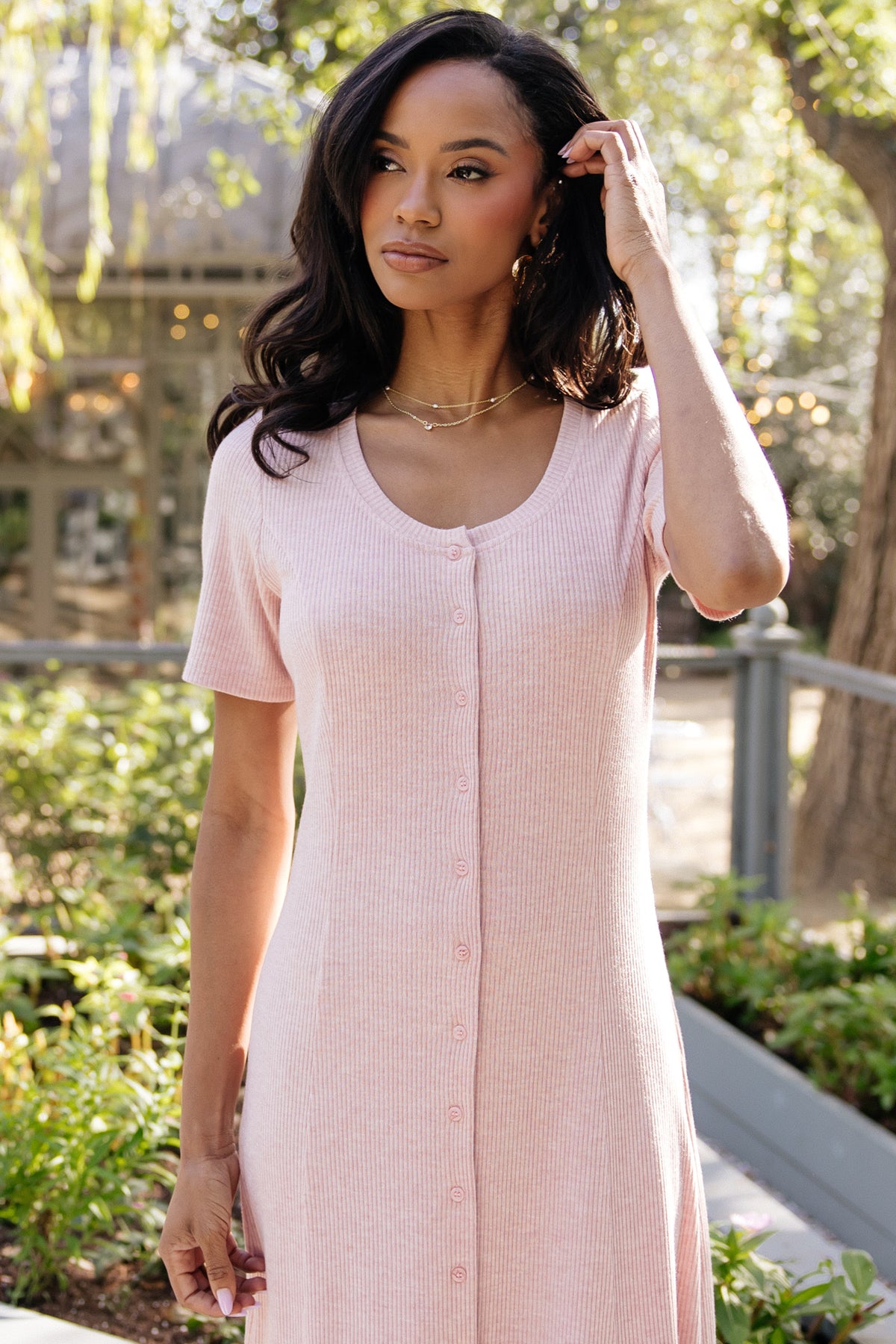 Back view of the Océane Midi Dress in blush, showing seam lines, fitted back, and mid-calf length silhouette on model.